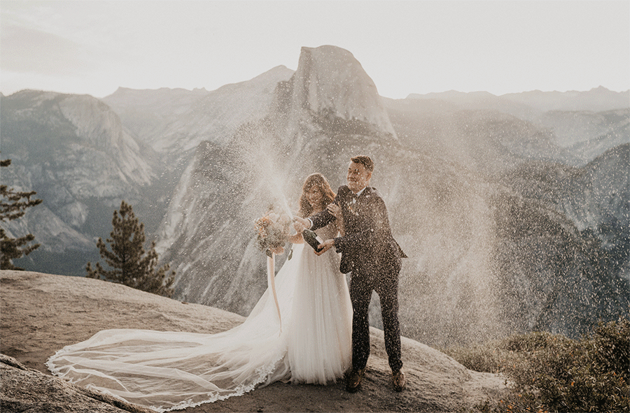 Bride and groom spraying champagne at Yosemite National Park