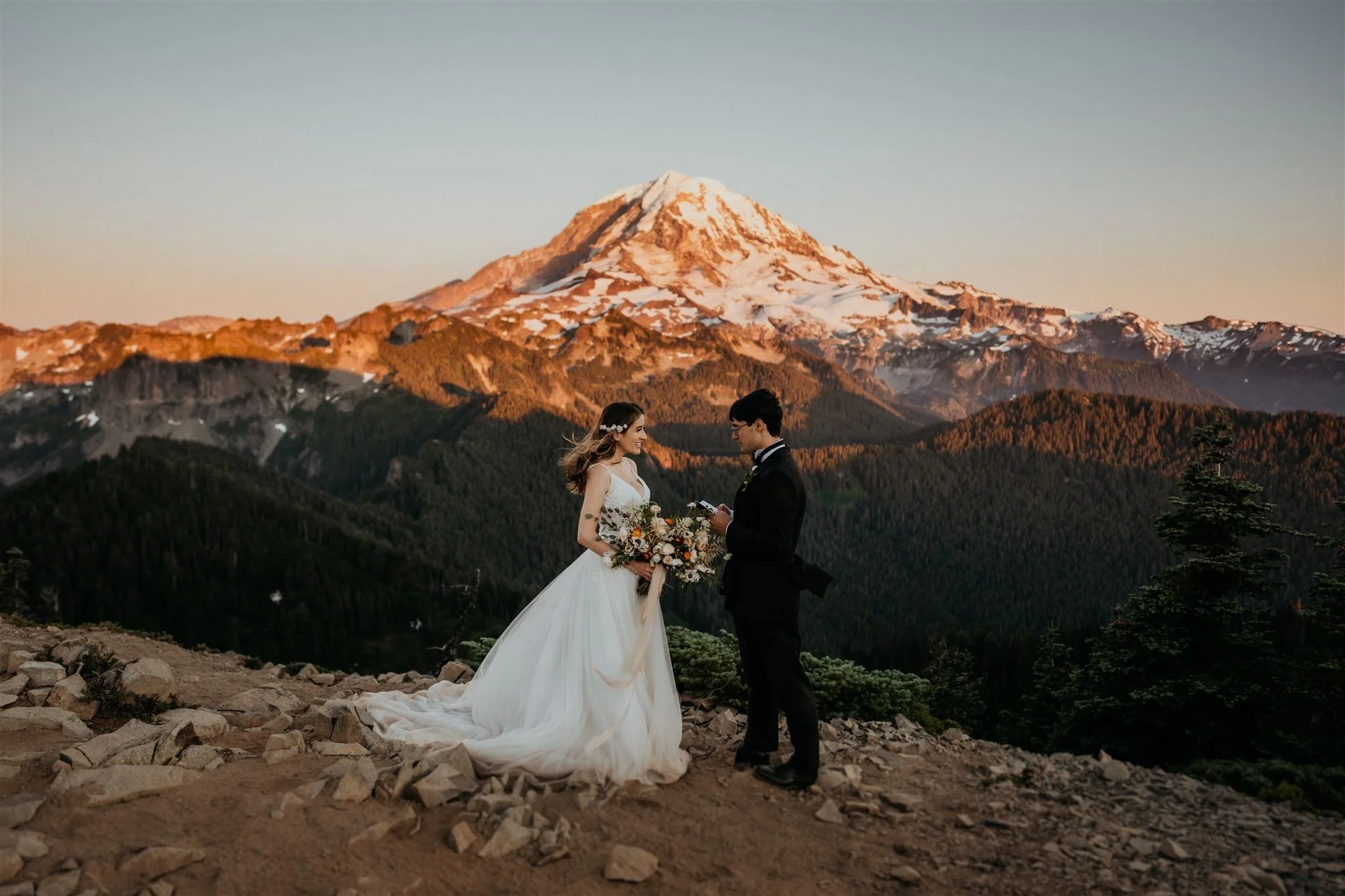 Bride and groom exchange vows during Mt Rainier National Park elopement at sunset