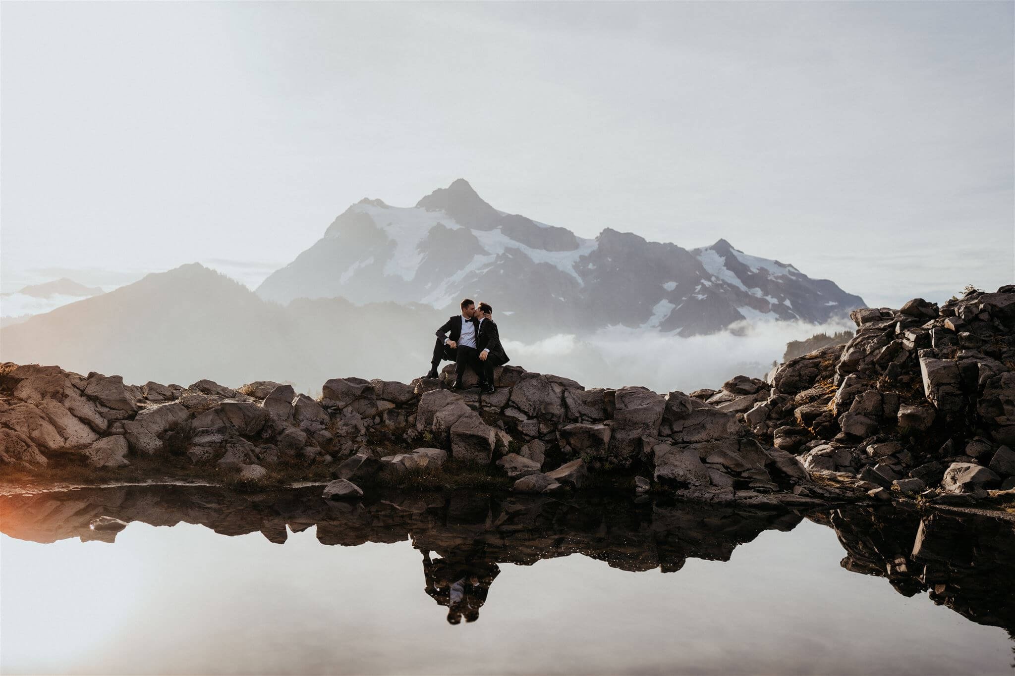 Two grooms kiss during mountain elopement in the North Cascades