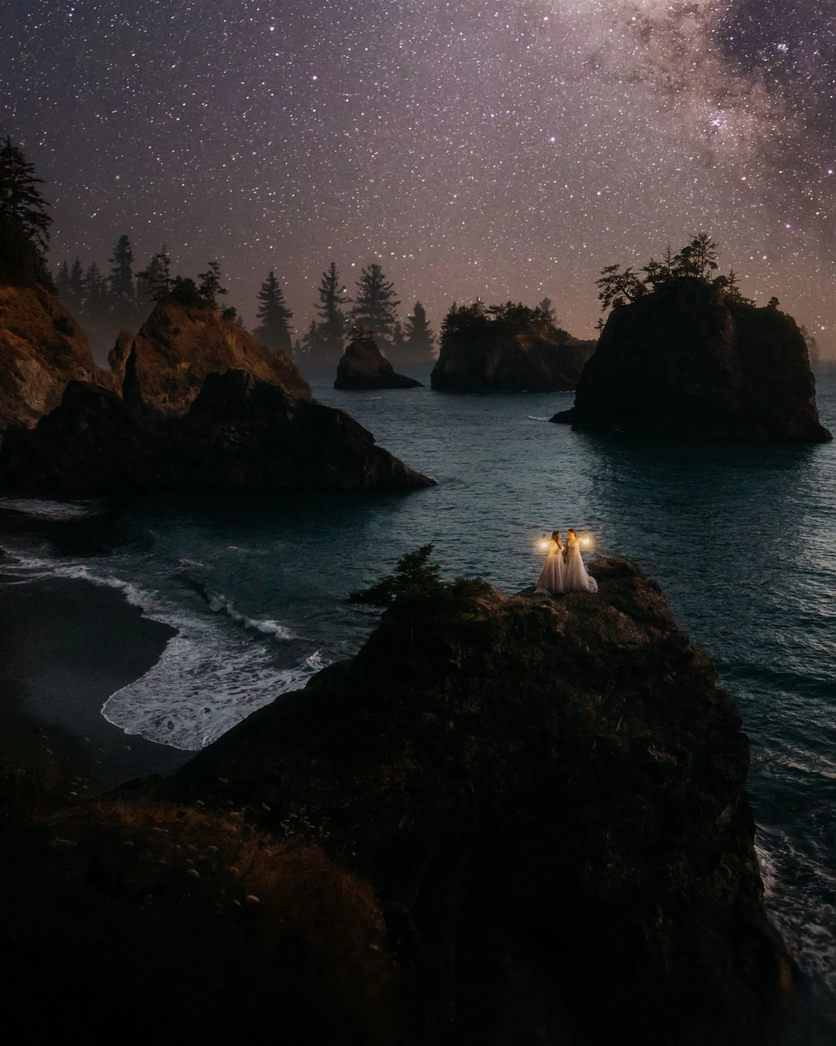 Award winning photo of two brides standing on top of a rock at their Southern Oregon Coast elopement