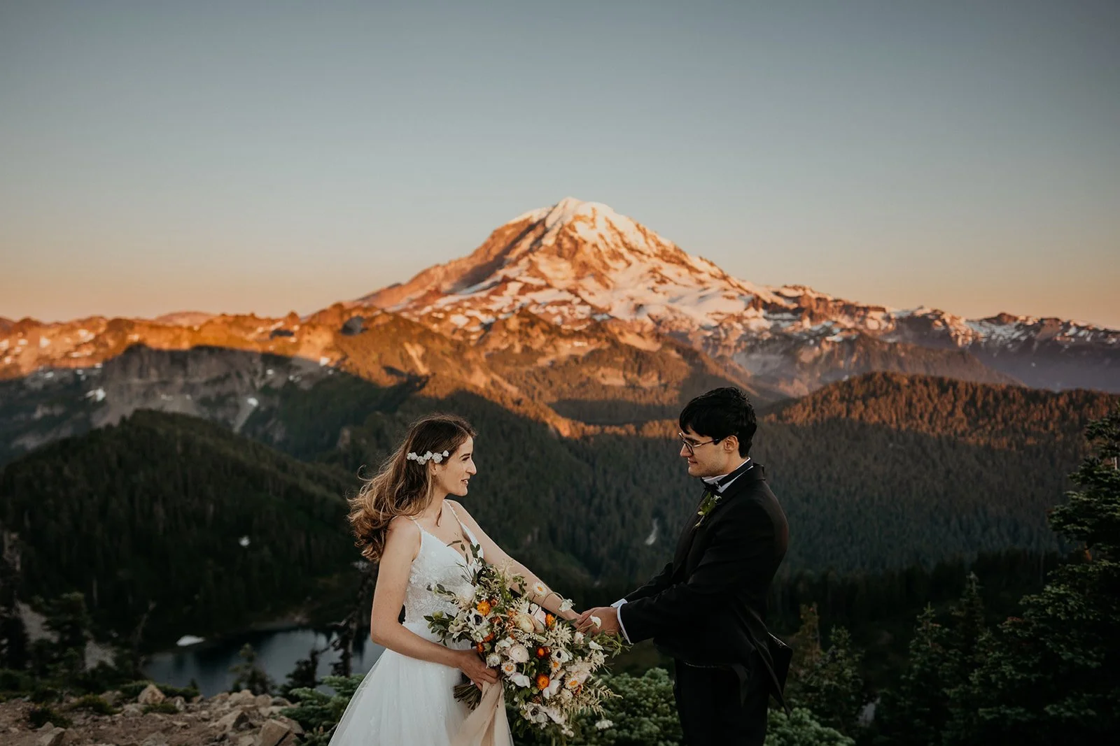 Bride and groom hold hands during their elopement at Mt Rainier National Park