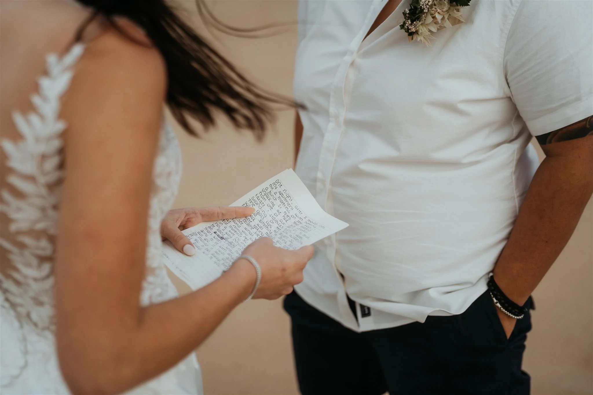 Brides read personal vows during their beach elopement in Hawaii