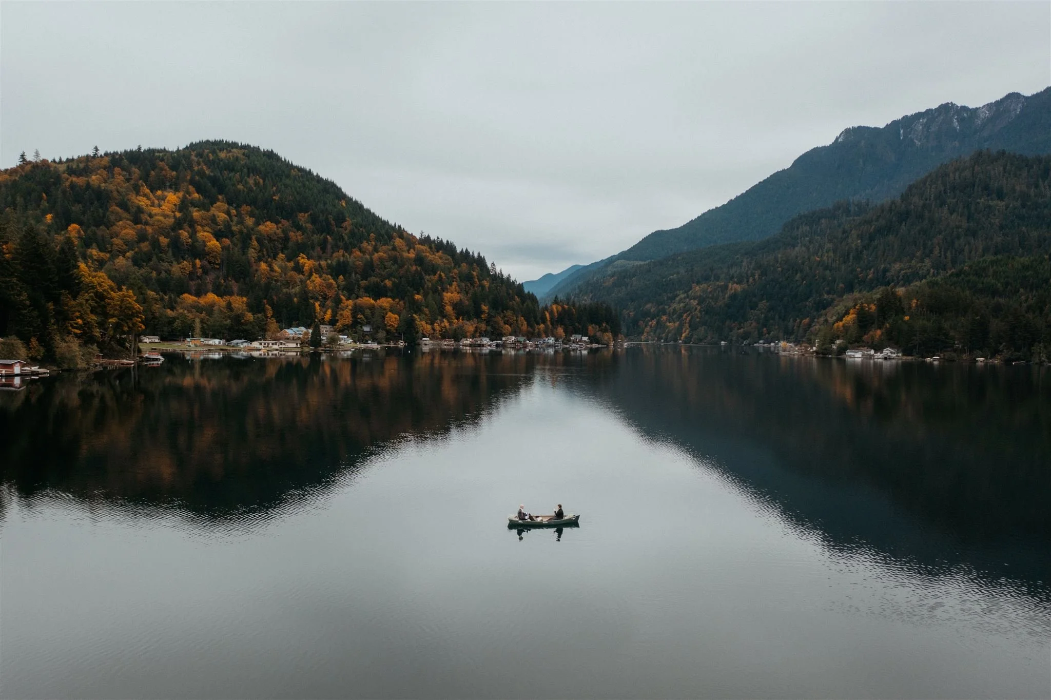 Bride and groom kayaking in a lake in the PNW on their elopement day