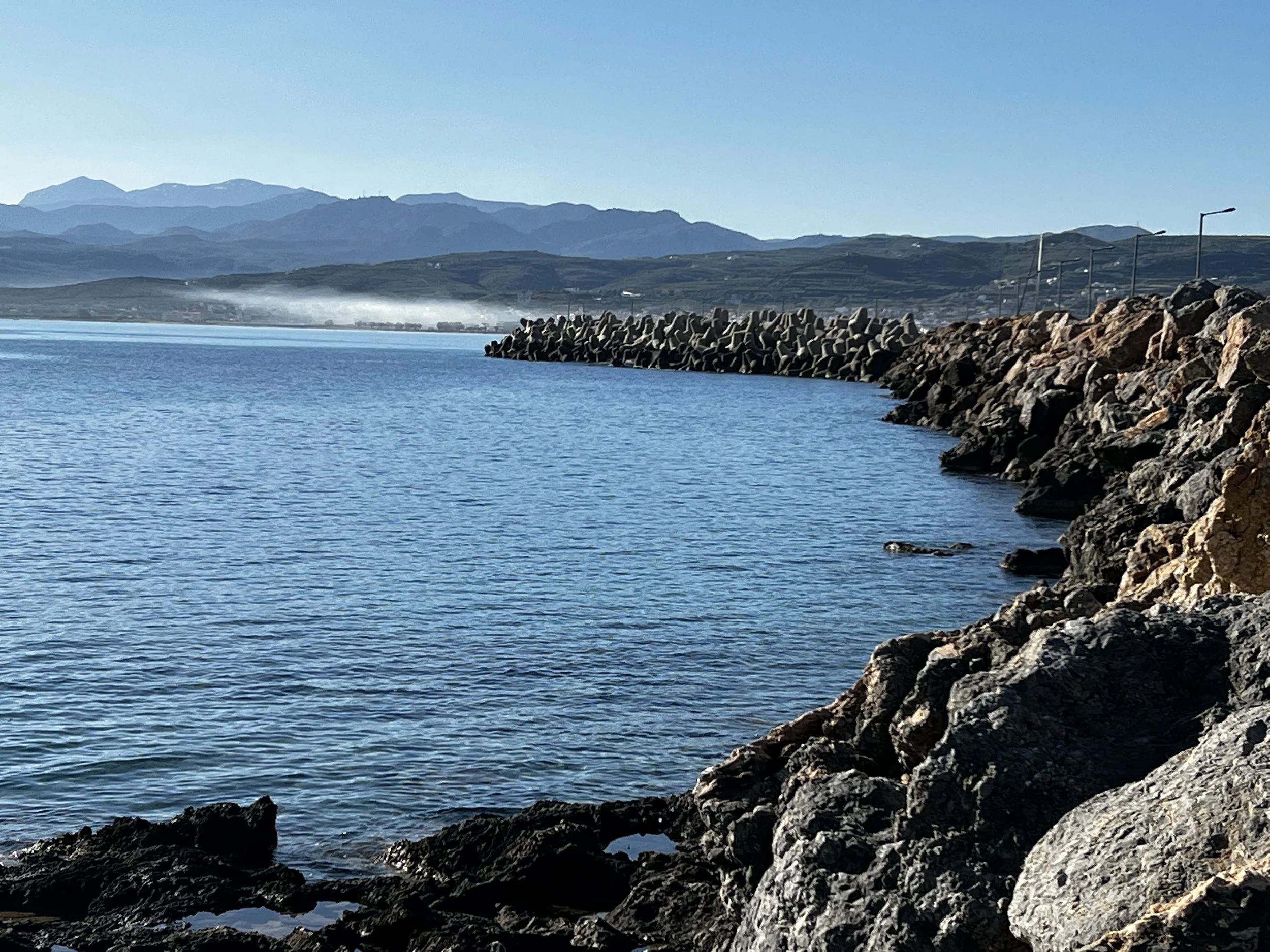 Calm body of water with a rocky shoreline