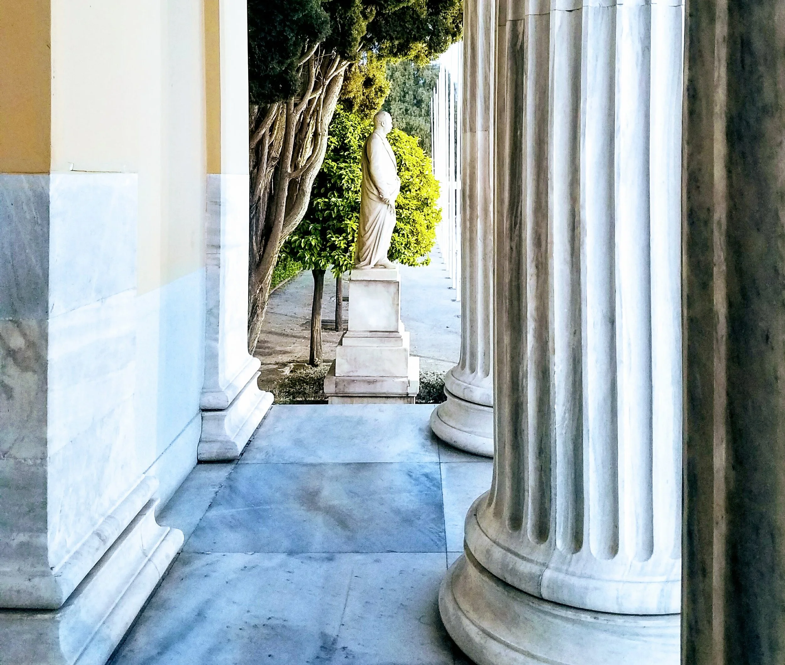 Marble statue and columns in Athens, Greece