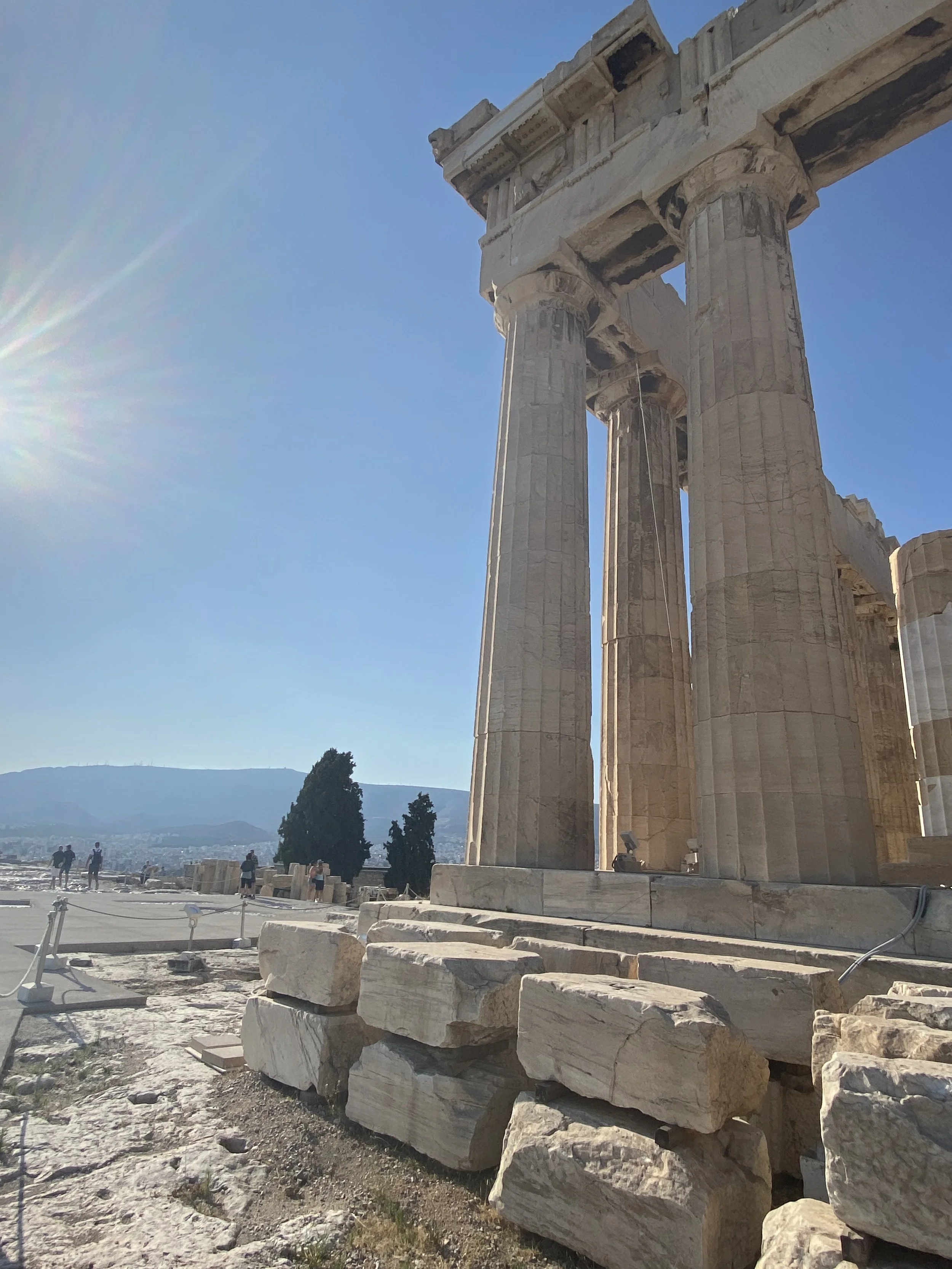 Parthenon ruins under a clear blue sky with sunlight, Athens, Greece