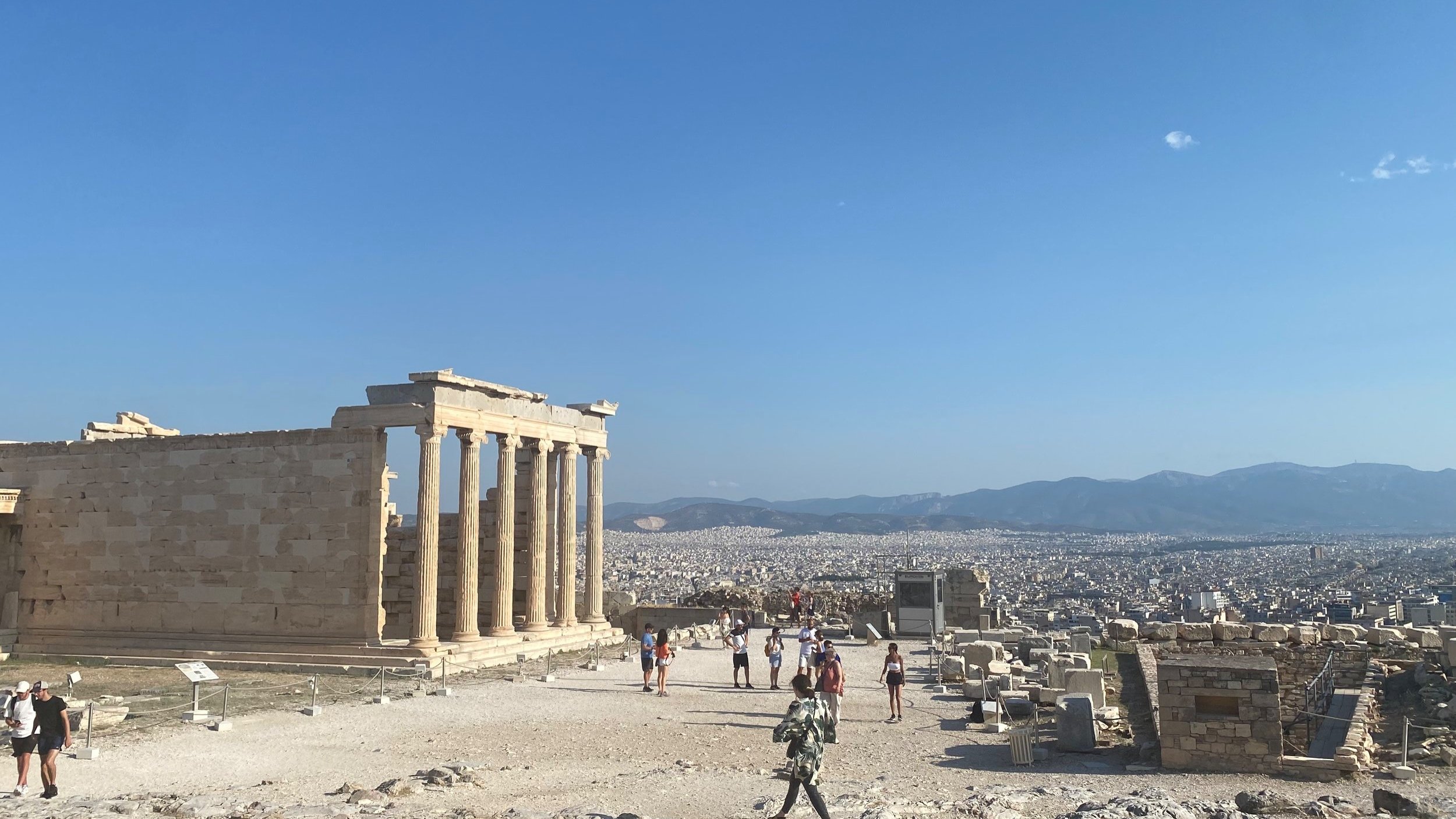 Acropolis ruins with tourists and cityscape view 