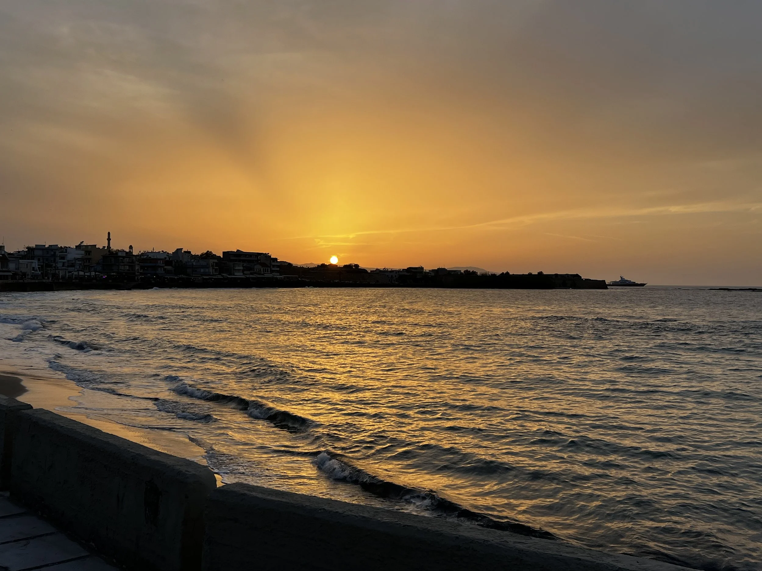 Sunset over a sea with waves