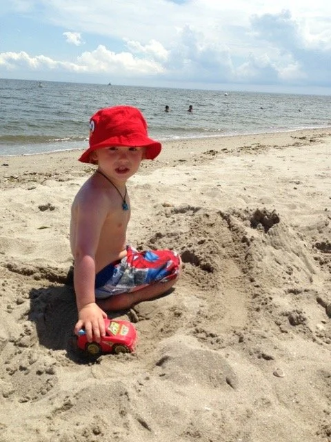 A young boy wearing a red hat, Fairfield, CT
