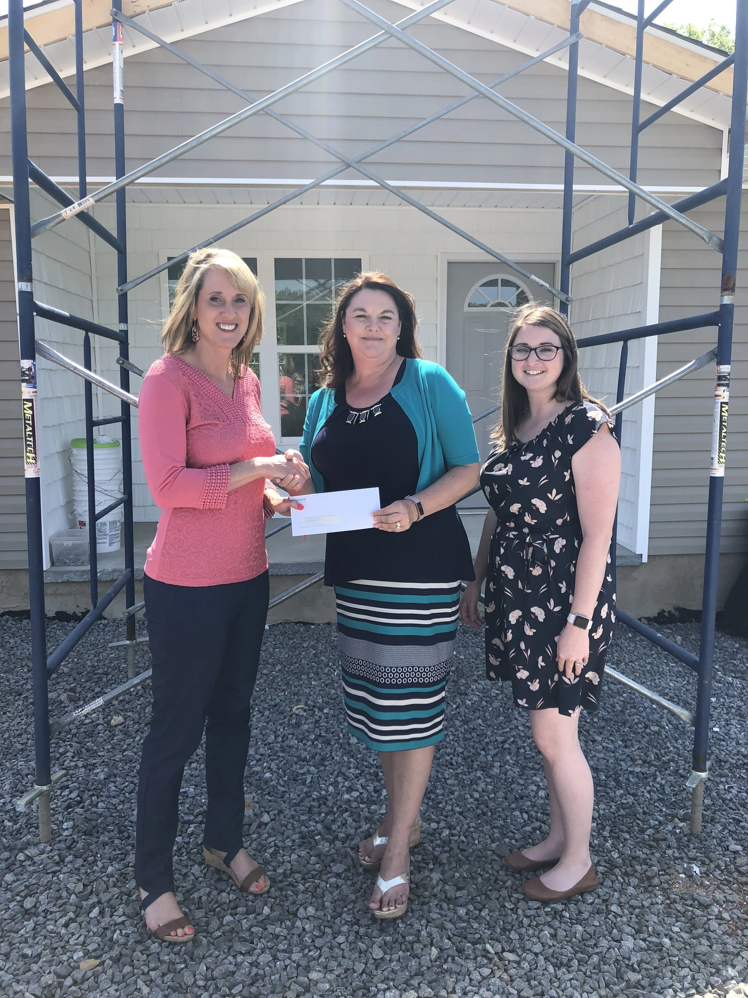 Tammy K. Johnson and Natalie McNair, Habitat for Humanity, accepted a check from Lisa Mantooth (Center), WACKER representative.