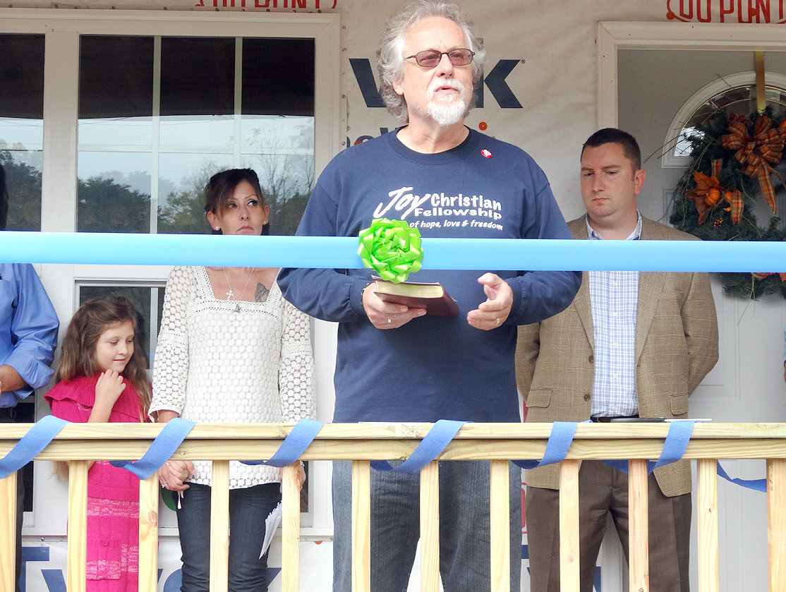 Bob Zwarych offers a Bible and a prayer ; Pastor Z has presented 81 Bibles to Habitat homeowners