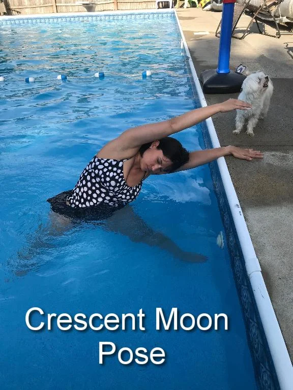 One foot is pointed toward the side of the pool while the other foot is perpendicular. Legs are wide apart, about 3-4 feet. The arm closest to the side of the pool will rest on the side while the other arm reaches straight up to the sky. Begin to lean toward the edge of the pool until your feel a gentle stretch. Hold. Repeat on other side. 