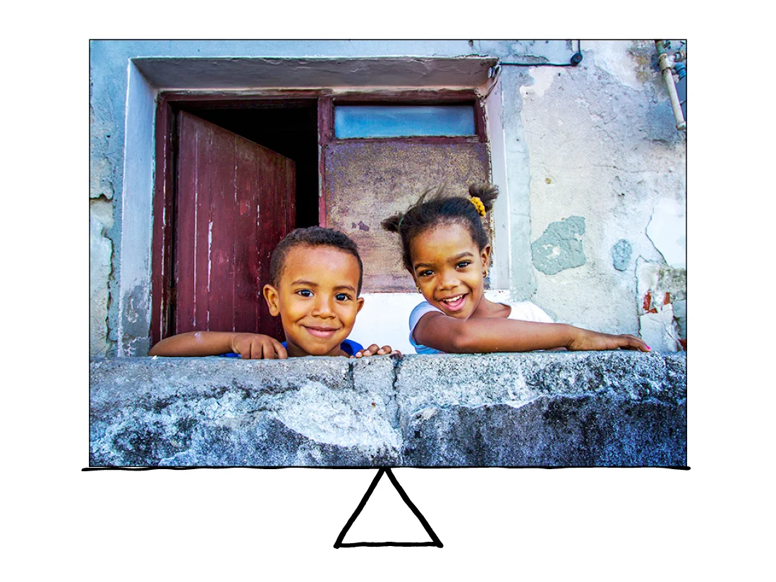The two Cuban children of the same size, equally spaced, creates a balanced photo. The two were shy at first, but once I started chatting with them and cracking some jokes, they quickly turned into little models.