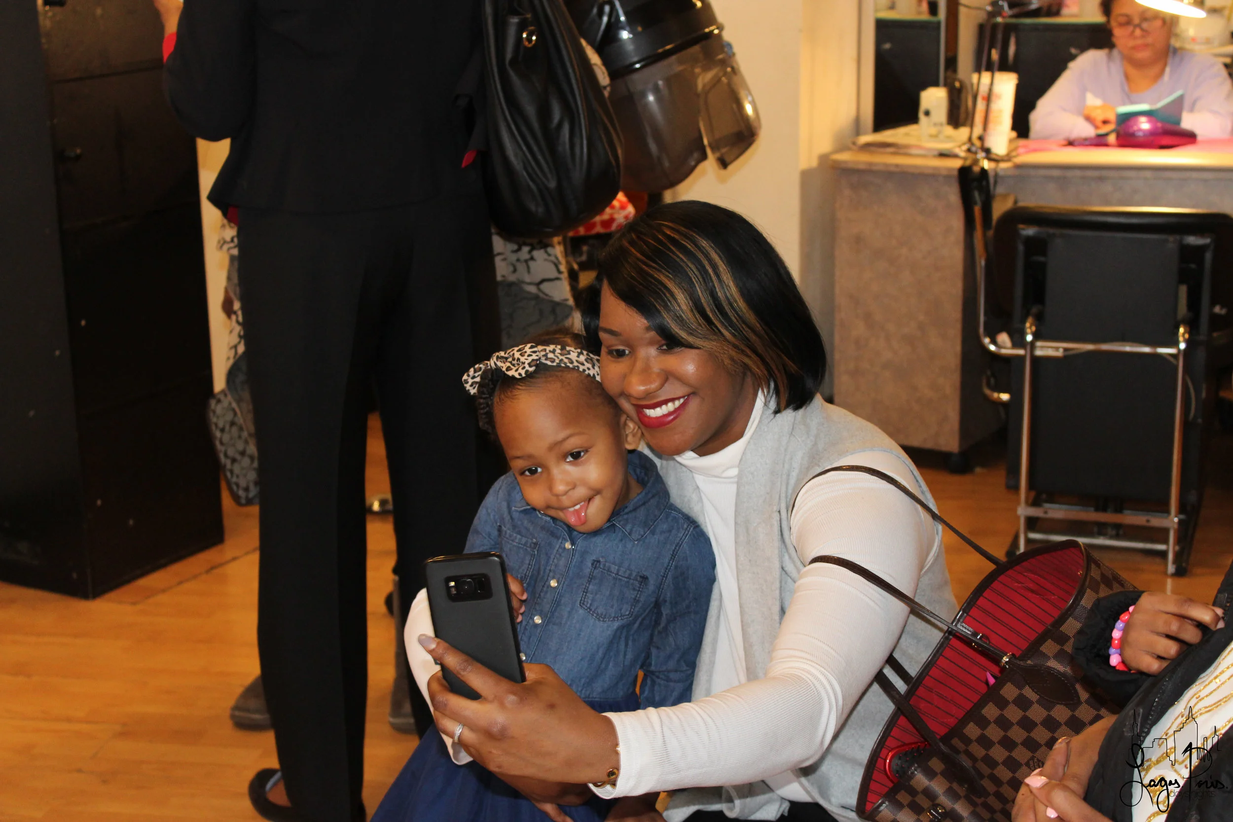 A mother and daughter, embody the spirit of the event with a fun selfie!