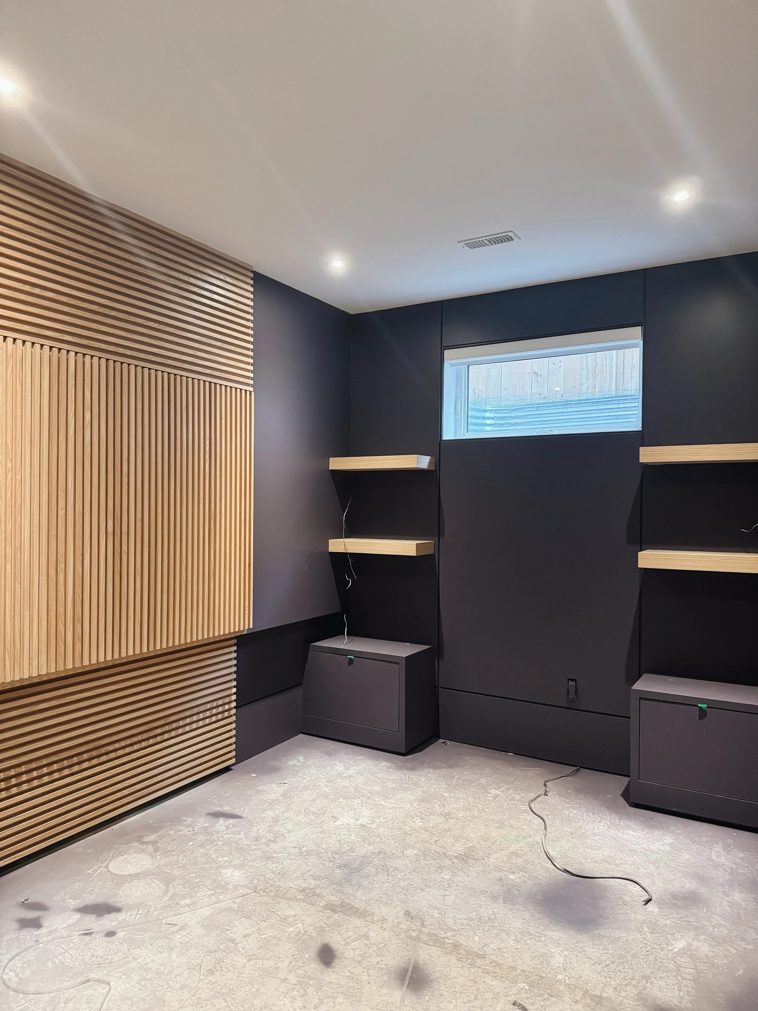 A look back at a custom office we built last year. Dark MDF wall paneling and a hand-cut oak slat compartment made to hold the client&rsquo;s specialized tools. 

#CustomMillwork #OfficeMillwork #torontohomes