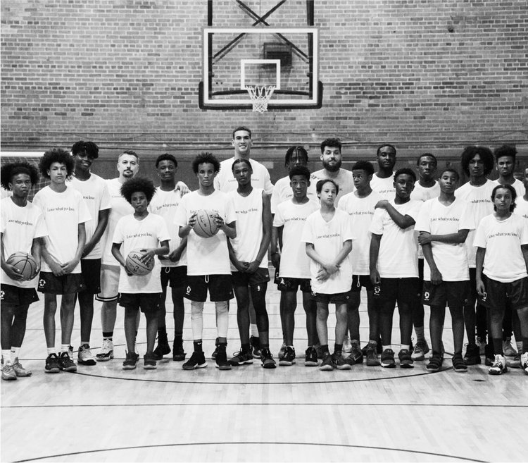 Group of Kickback Foundation kids posing on a basketball court