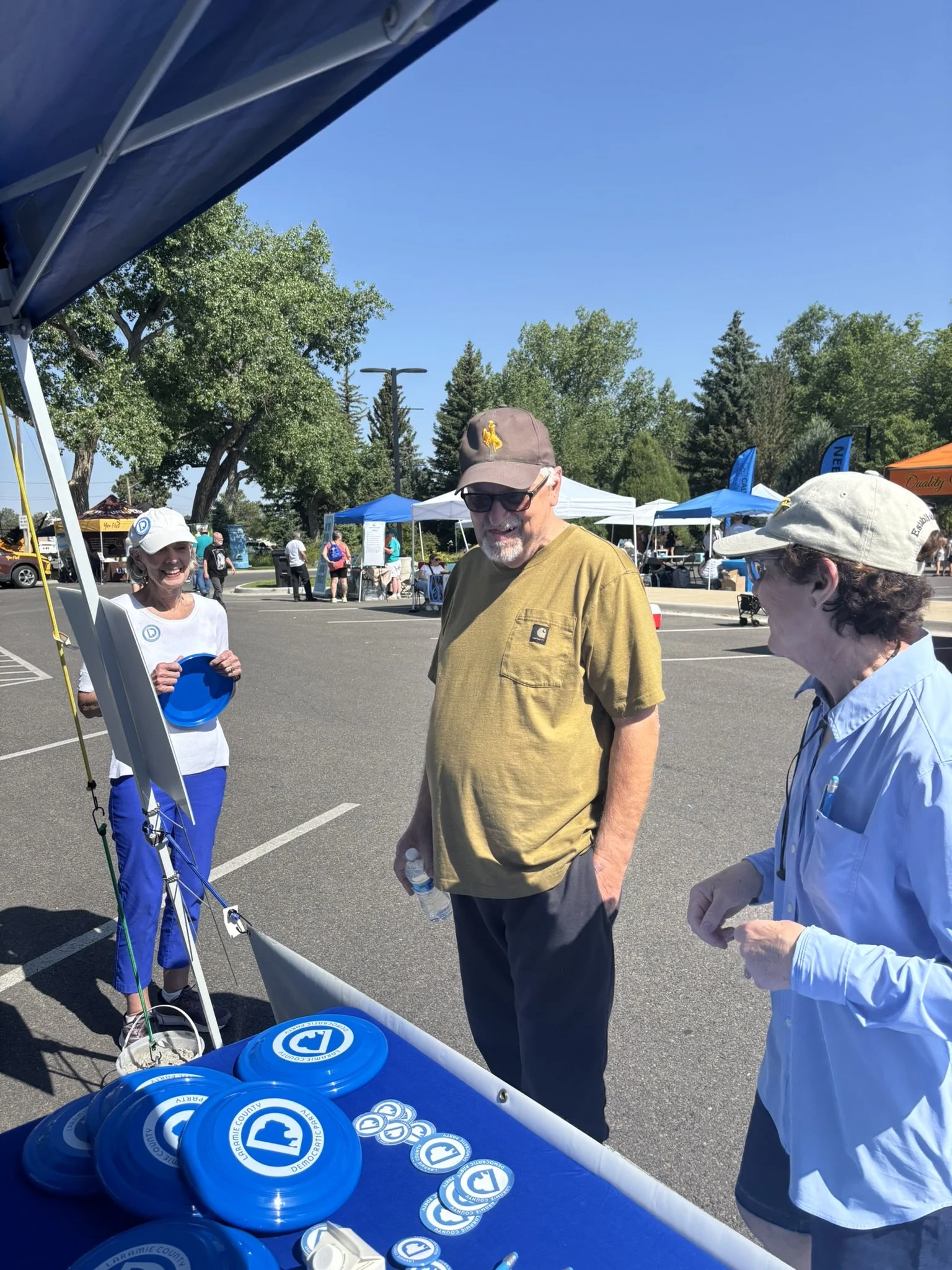 Cheyenne residents look over the Laramie County Democrats booth at Cheyenne Superday
