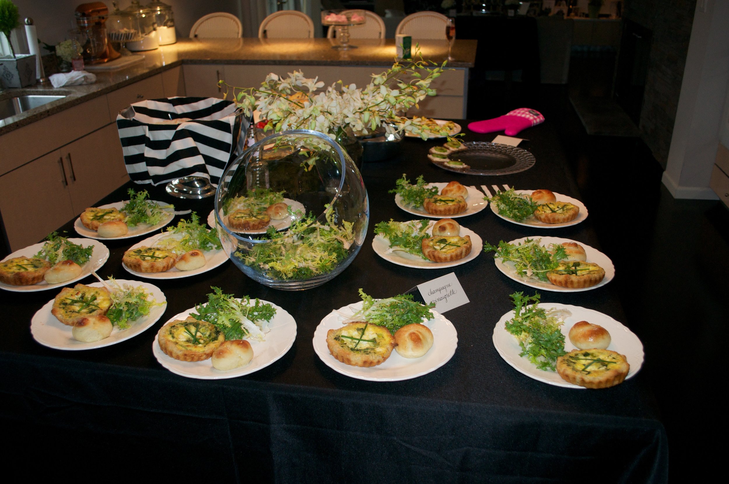 Mini gruyère quiches and garlic knot rolls with frisée salad and champagne vinaigrette