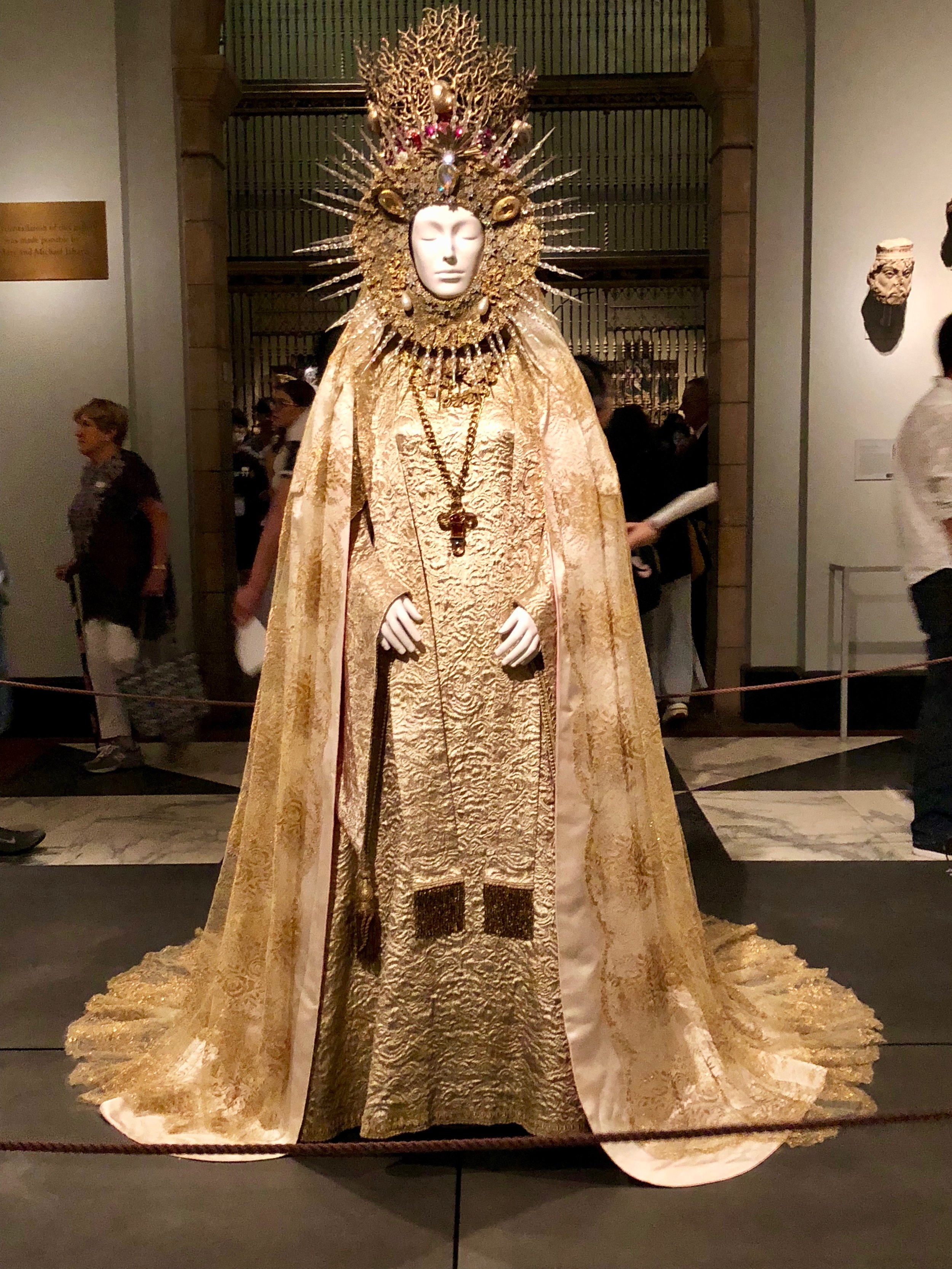 Yves Saint Laurent and Goossens, Statuary Vestment for the Virgin of El Rocio, 1985. Gold silk brocade with white and pink satin, gold silk and metal Chantilly lace, gold metal with polychrome crystals and pearls.