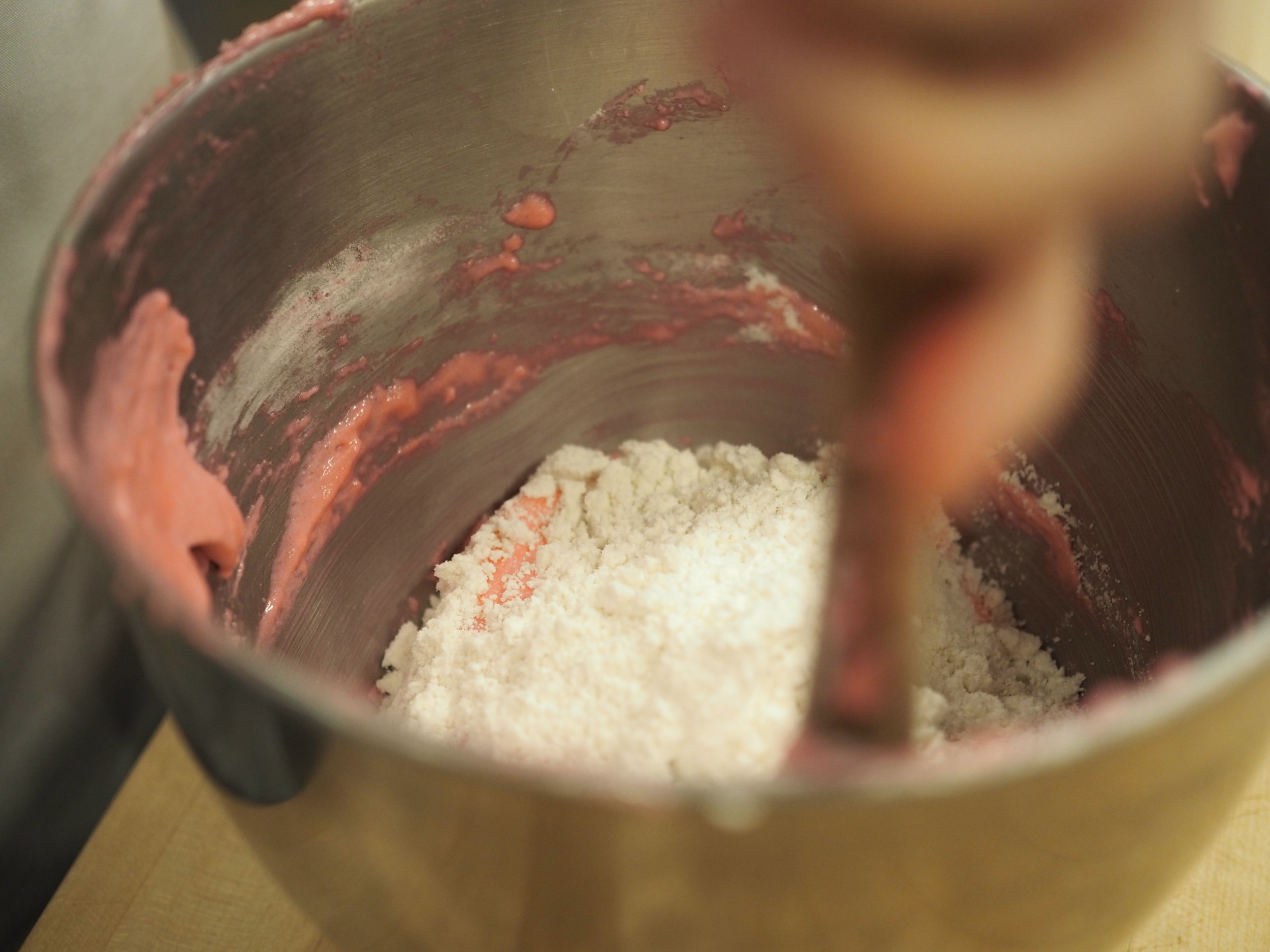 Folding the sifted mixture into the meringue