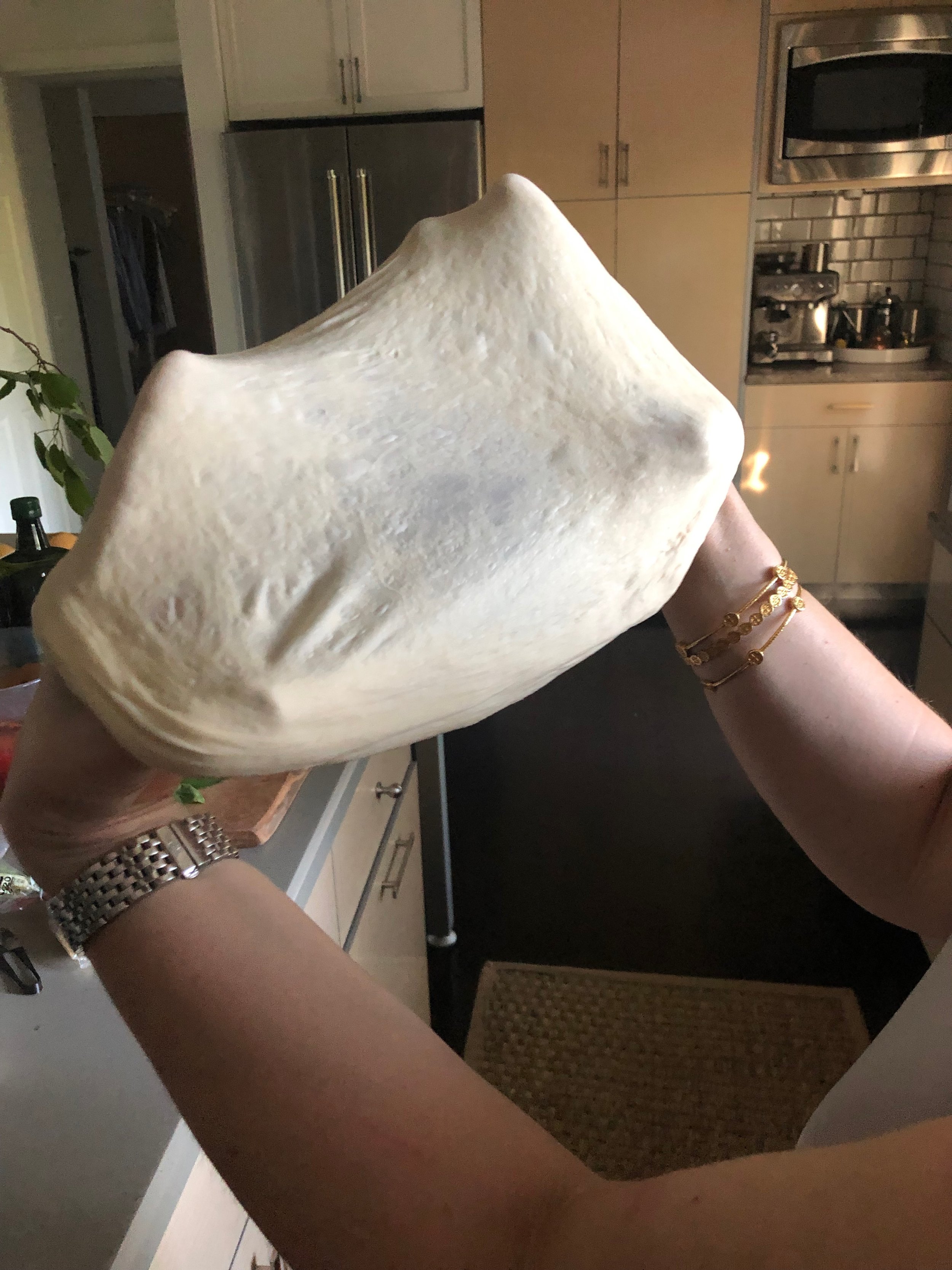 Stretching the pizza dough until transparent in the middle