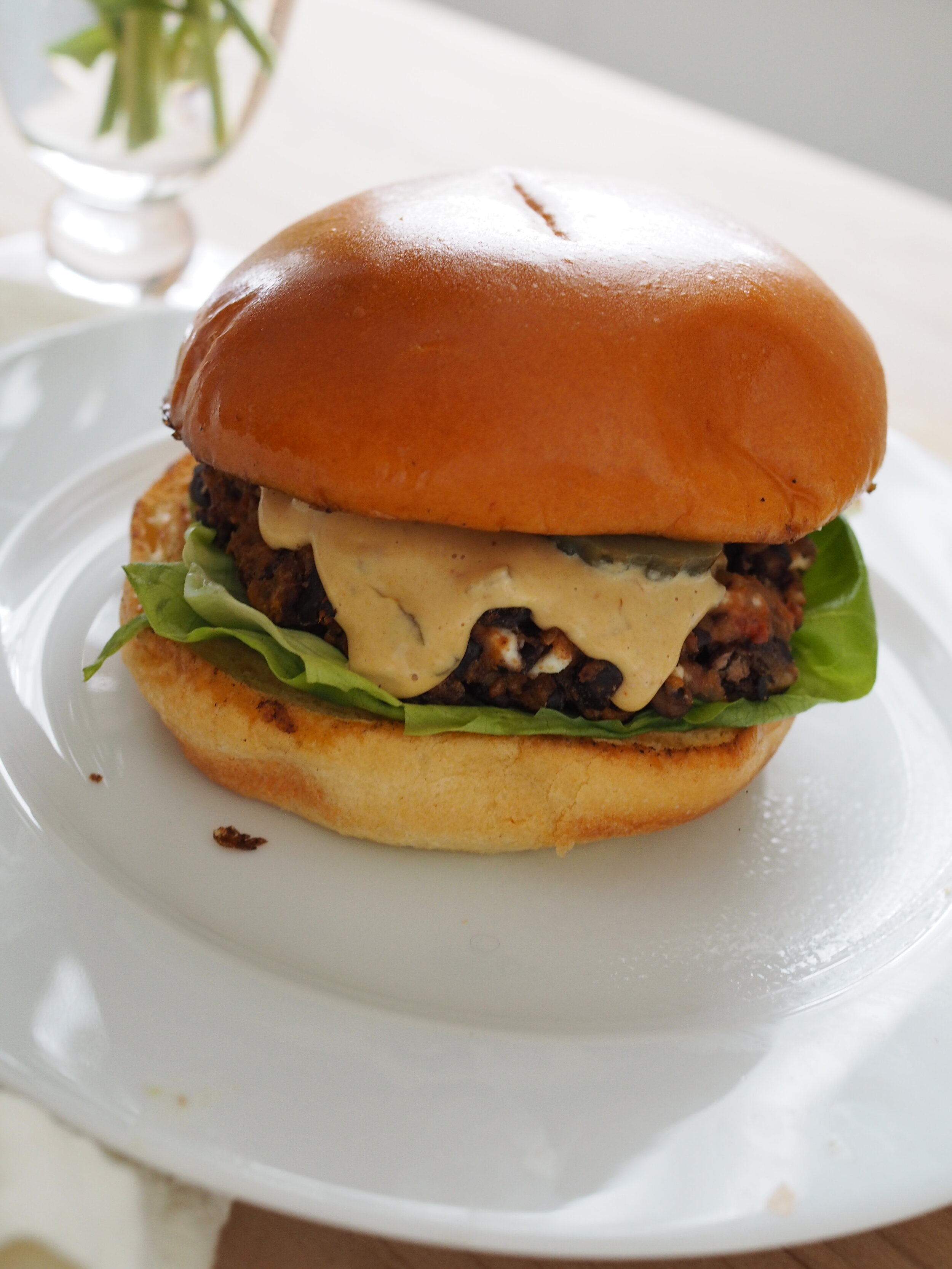 The best black bean burger served on a brioche bun with butter lettuce, pickles and fancy sauce