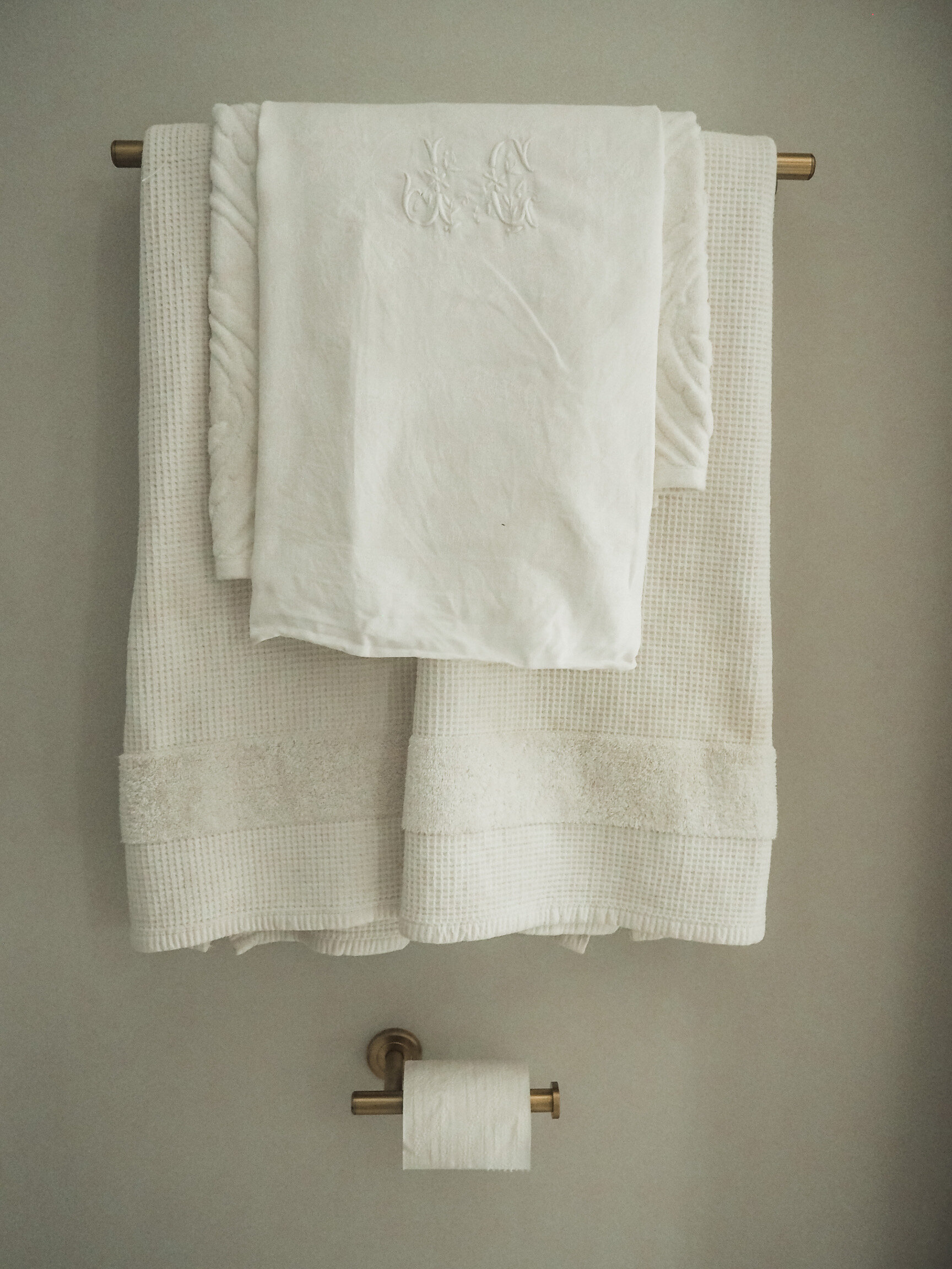 Simple white towels and an antique French linen napkin as a hand towel