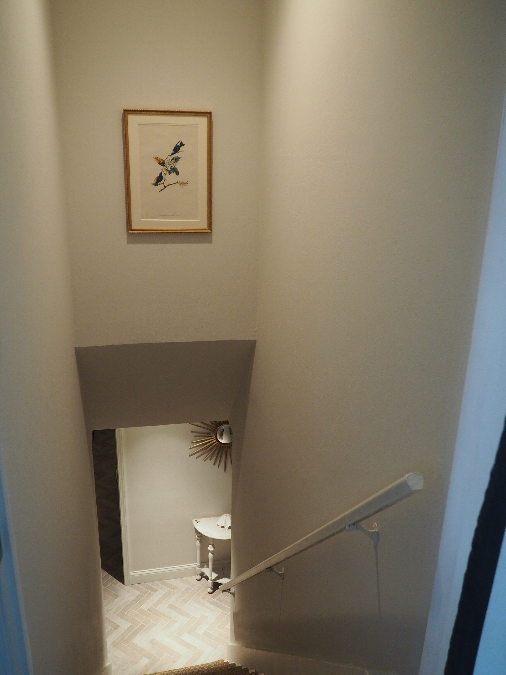 A pretty framed Audubon bird print in the stairwell