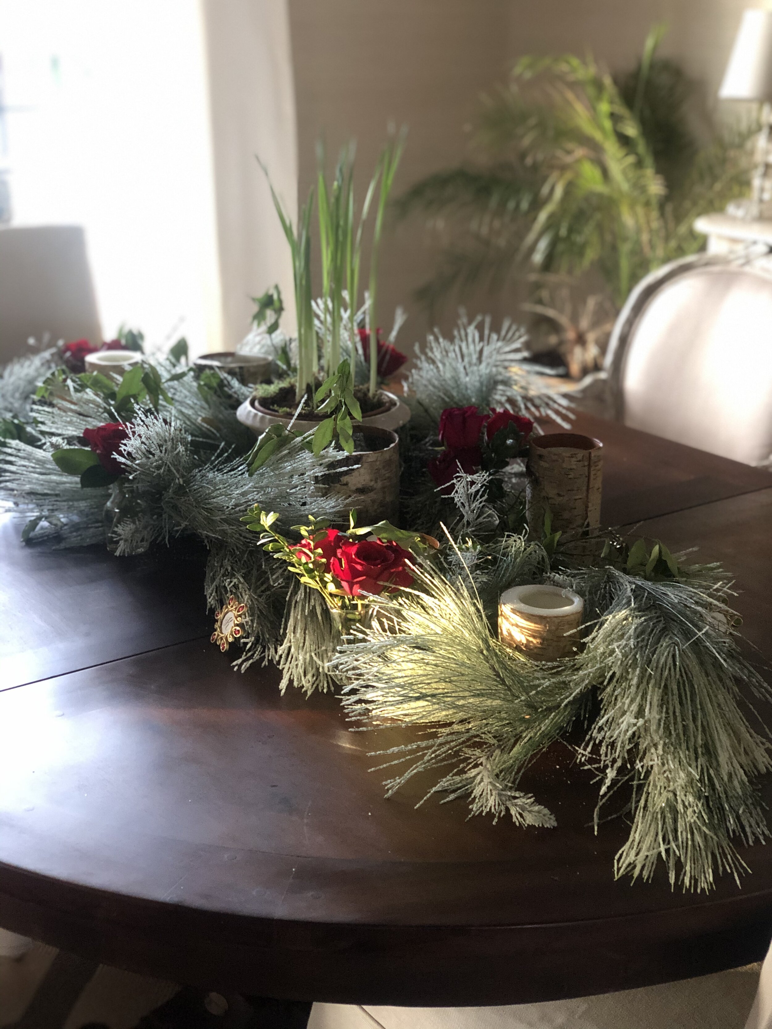 I love being able to add a leaf to our dining table as more are here to gather with us; I added this flocked greenery, birch candles and red roses to make it festive