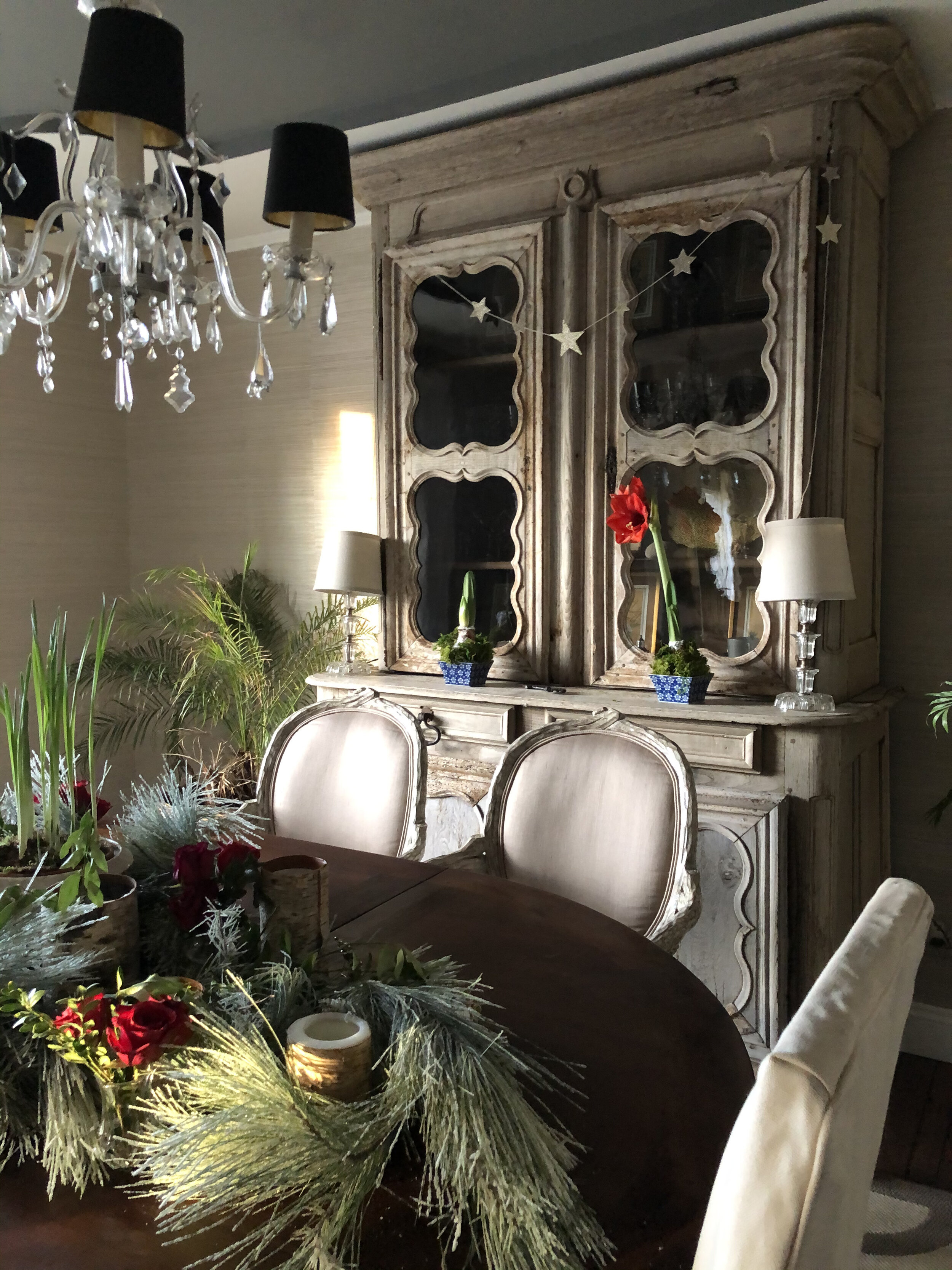 This stunning antique French armoire in our dining room is new to us this year, dressed up for Christmas with a simple DIY glitter star garland