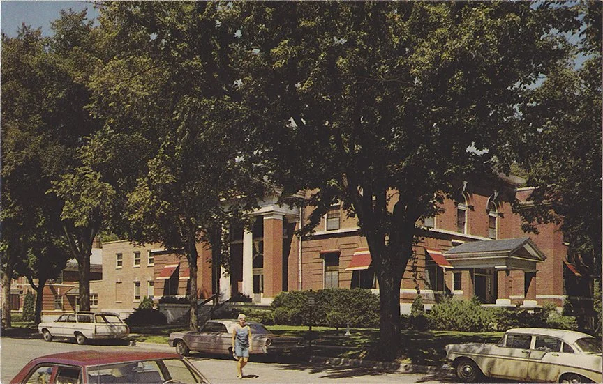 An early postcard shows the Green Lake County jail and courthouse standing side by side as part of the county government complex in Green Lake.