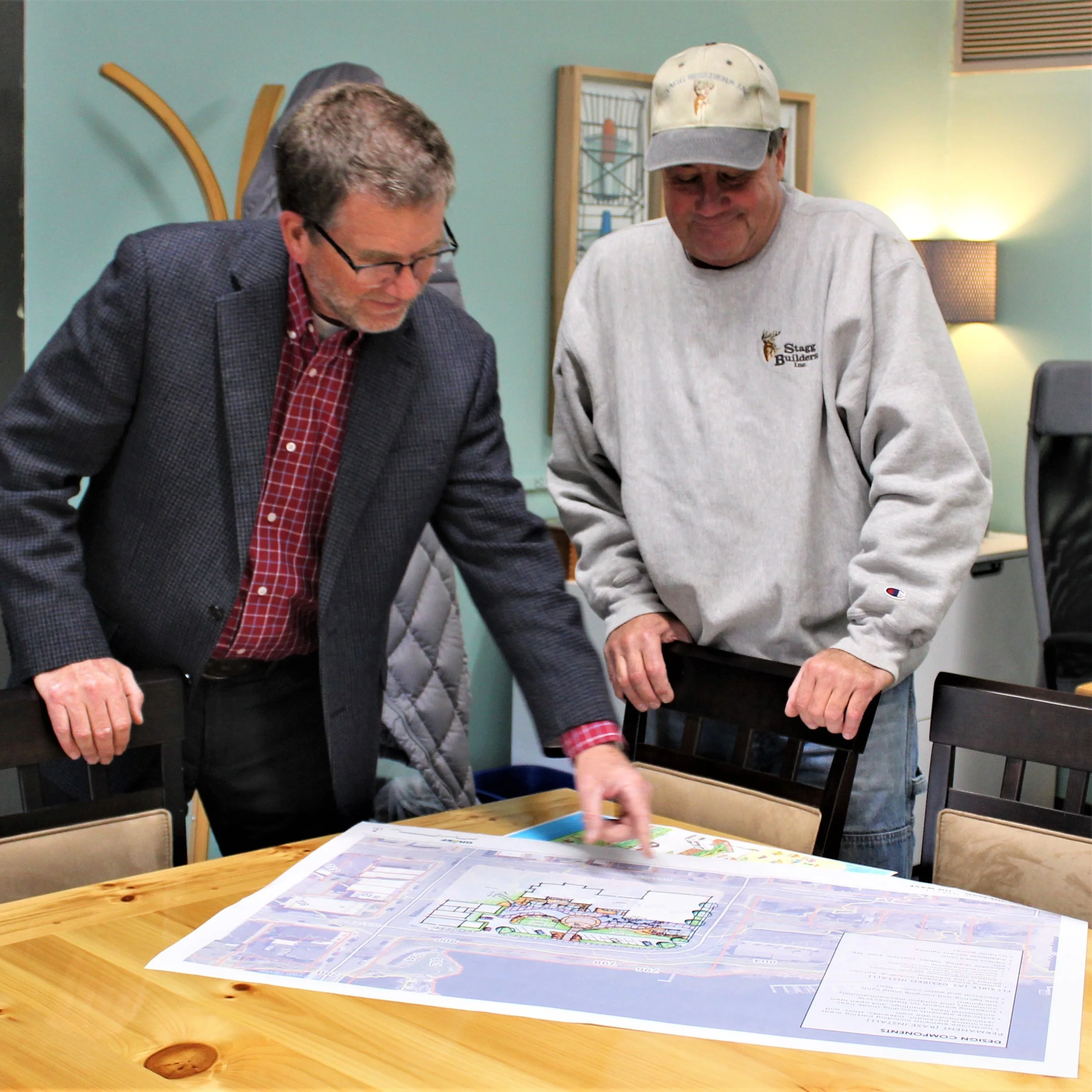 Phil Burkart of Green Lake Renewal and Mike Stagg of Stagg Builders discuss the elevations for Mill Pond Terrace.