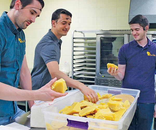 Checking out some chunks of wax for tinted lip balm are, from left, Scott Haskins, Jon Dudzinski and James Wiciak. Ariana Hones photo.