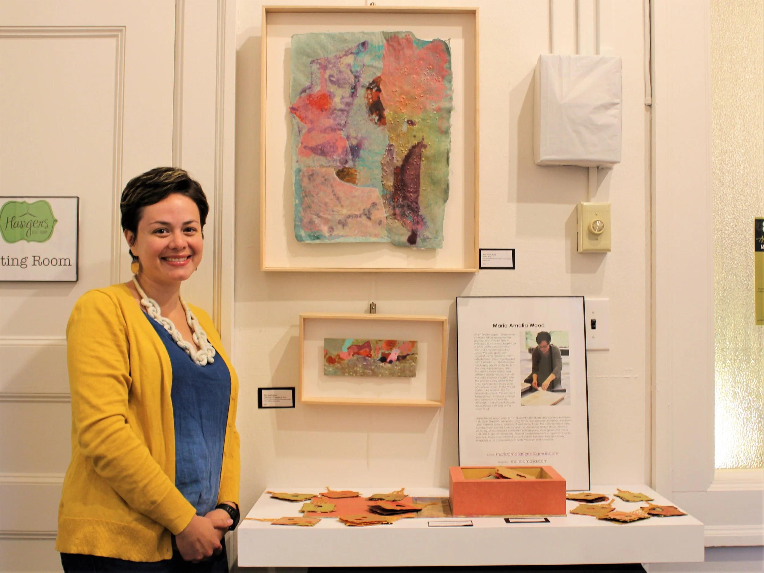 Winner of the 2017 Midwest Paper Fest juried show, Maria Amalia Wood, poses next to her artwork. Her winning composition featured leaves made of handmade paper accompanied by a short poem: "Dancing in the wind/ falling down slowly/ a leaf celebrates freedom."
