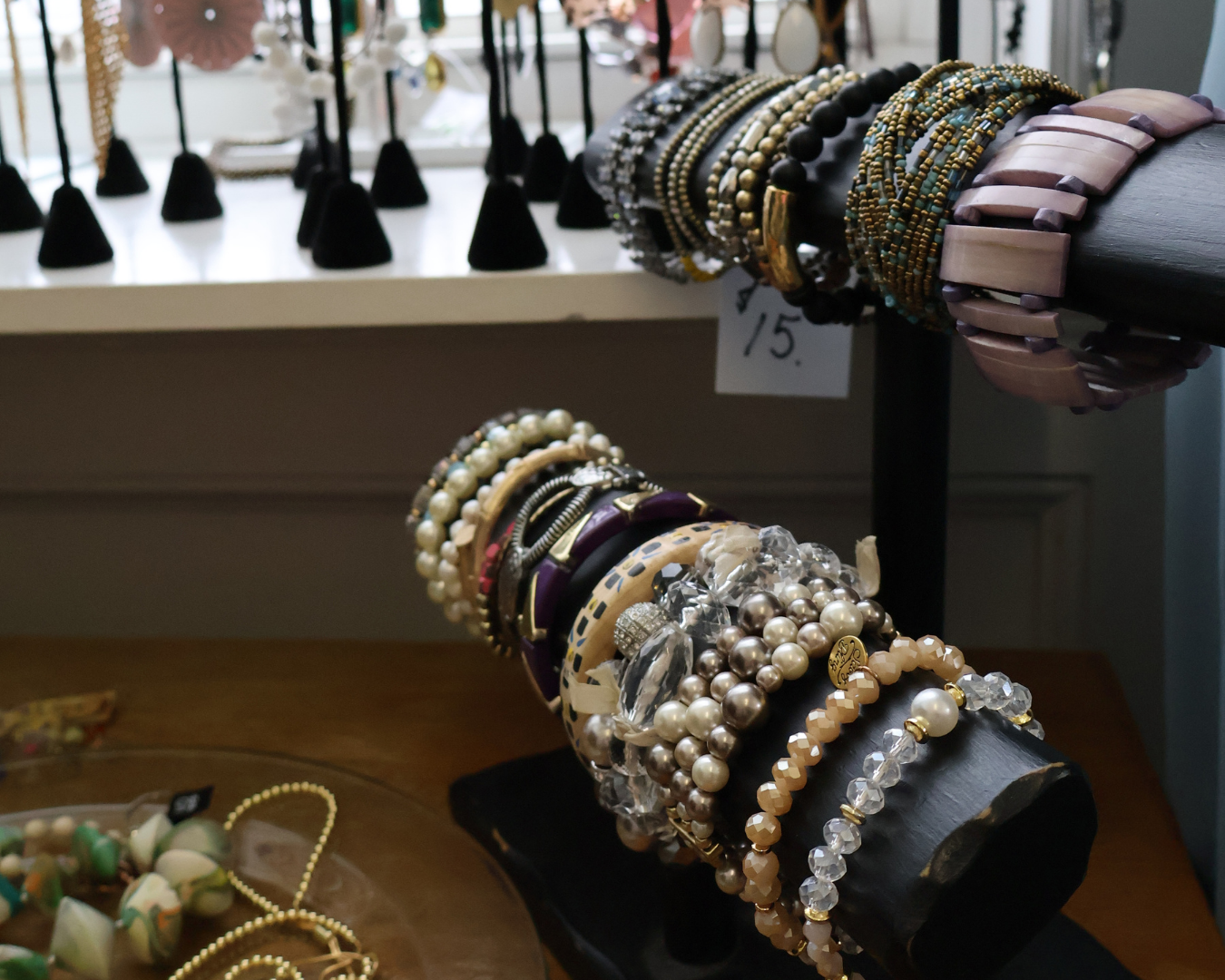 Bracelets, necklaces, and other jewelry displayed at Hangers Resale Shop in Green Lake.