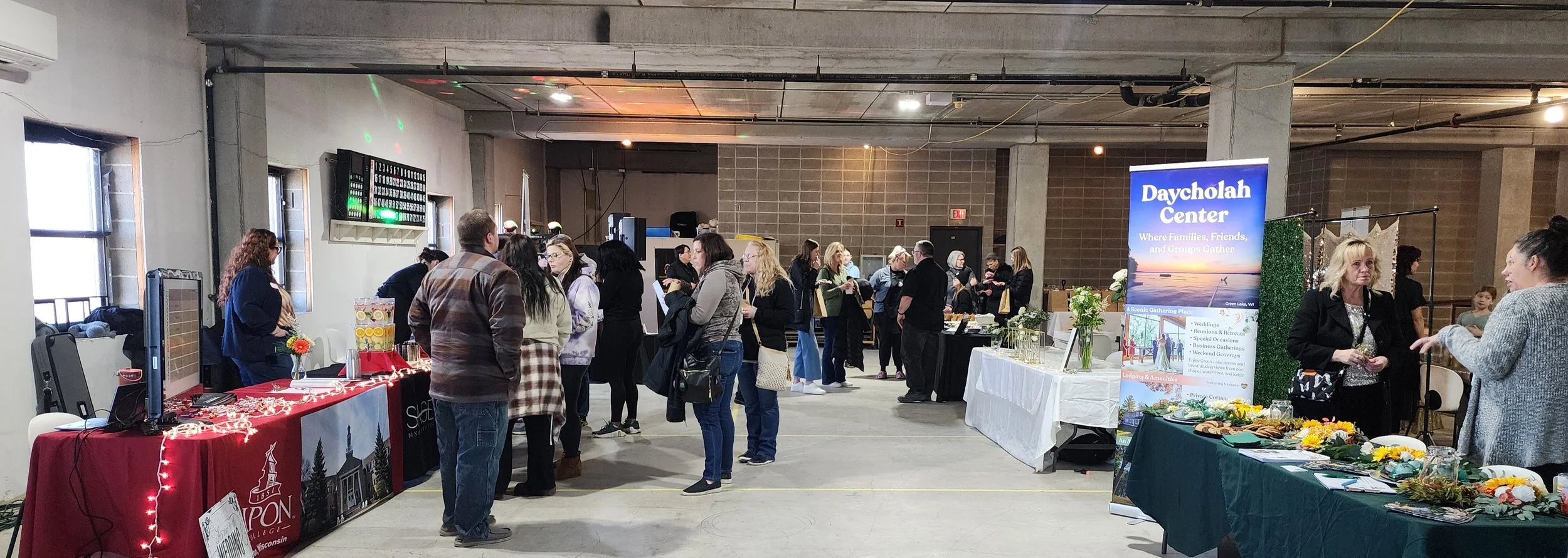 Visitors explore exhibitor booths and connect with local vendors during the Wedding & Event Expo at Town Square Community Center in Green Lake, Wisconsin.