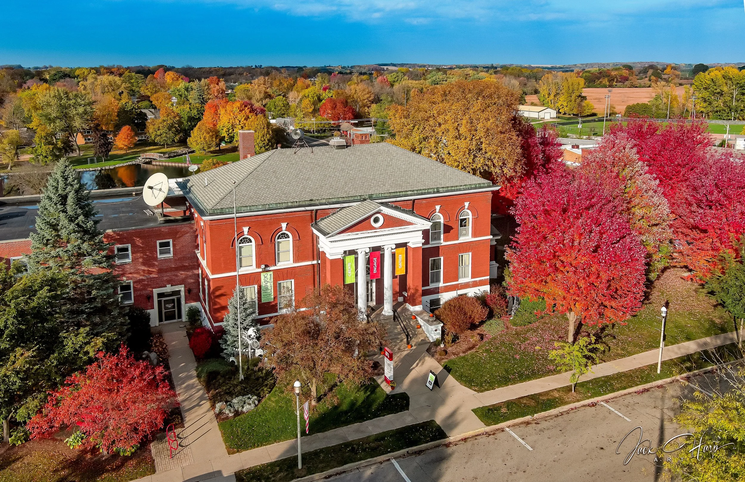 Aerial view of Town Square Community Center in Green Lake, Wisconsin, surrounded by colorful fall foliage.