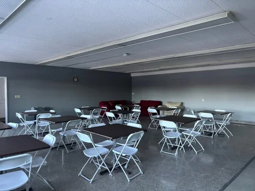 Club Room at Town Square Community Center set up with tables and chairs for meetings, activities, and small gatherings.