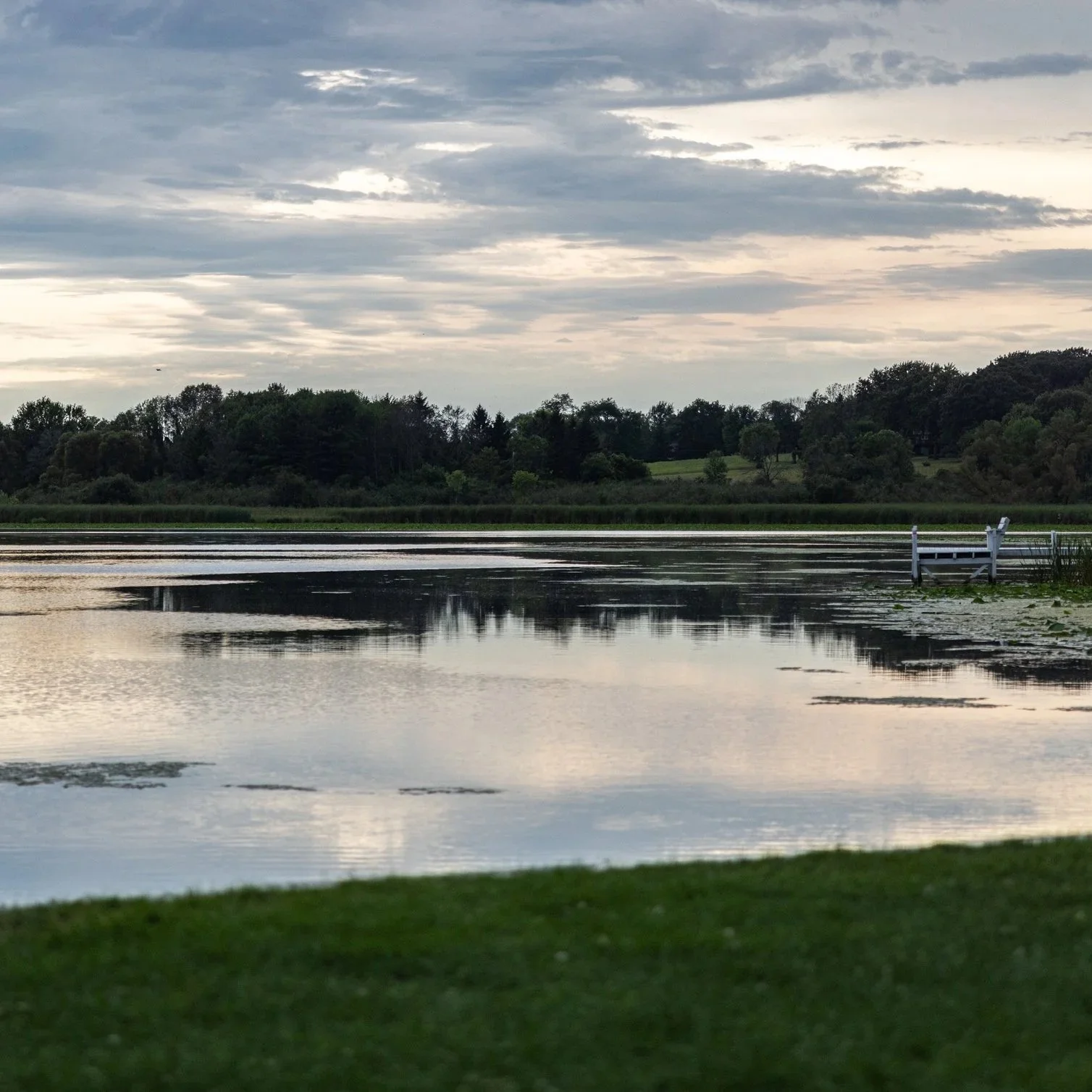 Peaceful view of Green Lake, Wisconsin, home to the annual Green Lake Fine Art Show, where visitors enjoy fine art, local artists, outdoor exhibits, and community art events throughout the weekend.