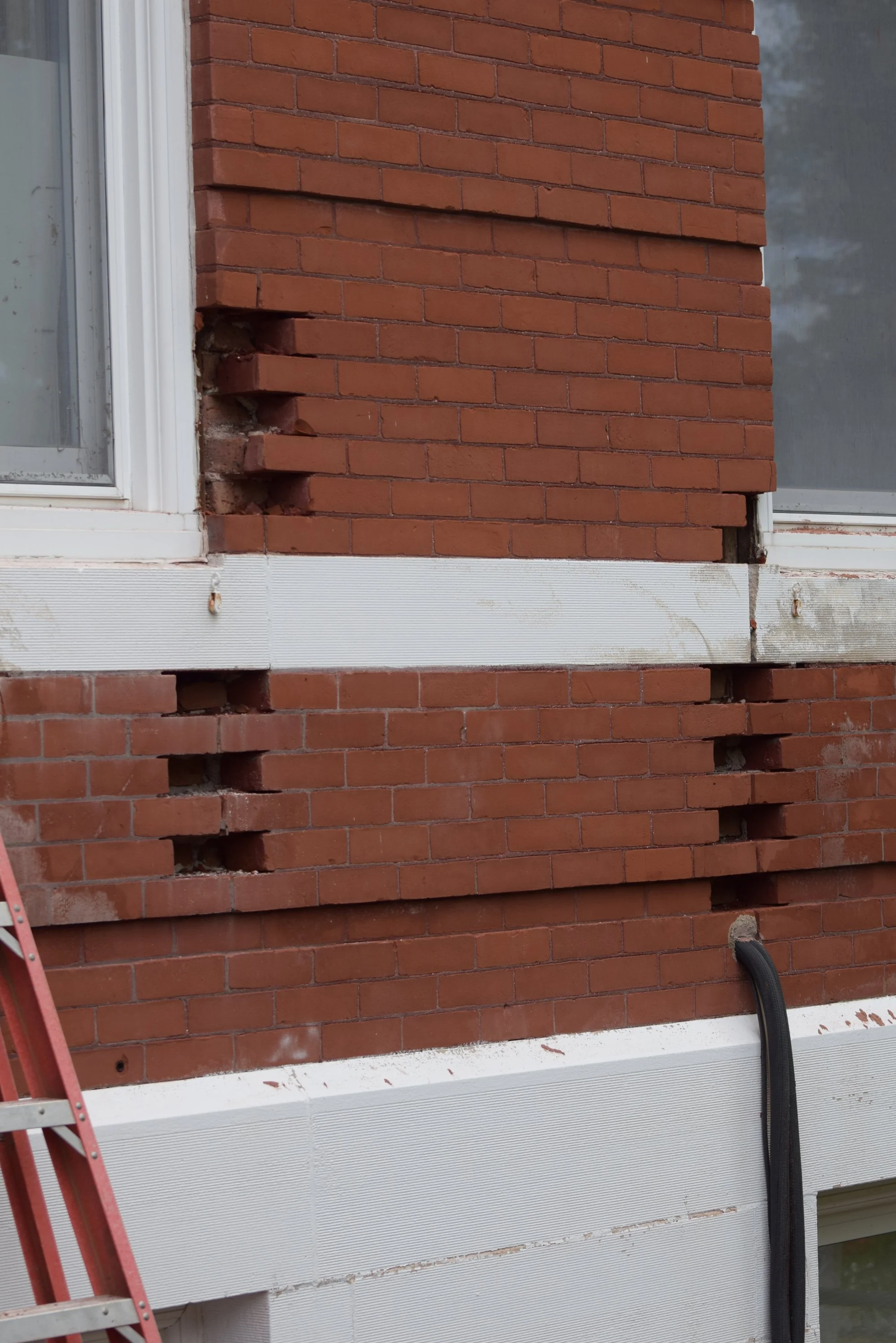 Close-up of decorative red brickwork and a window on the historic Town Square building.
