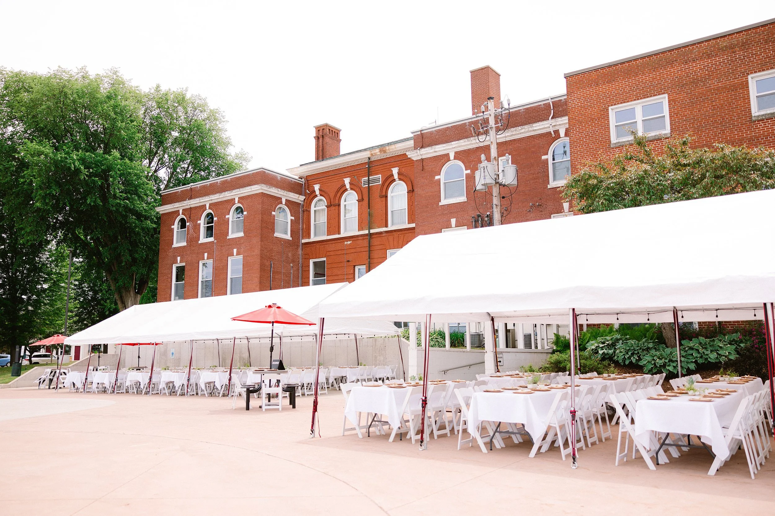 Large white Terrace Tent set up with tables and chairs outside Town Square Community Center in Green Lake, Wisconsin.