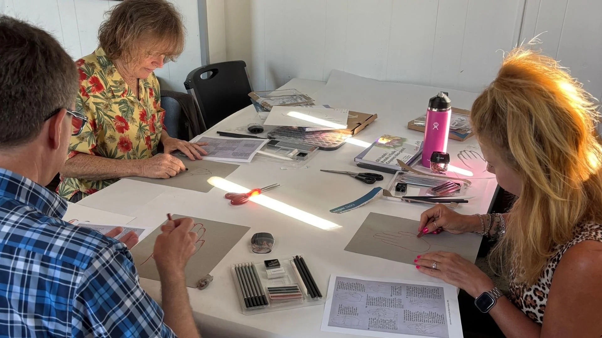 Participants practice drawing techniques during a hands-on Art MidWisconsin class at Town Square.