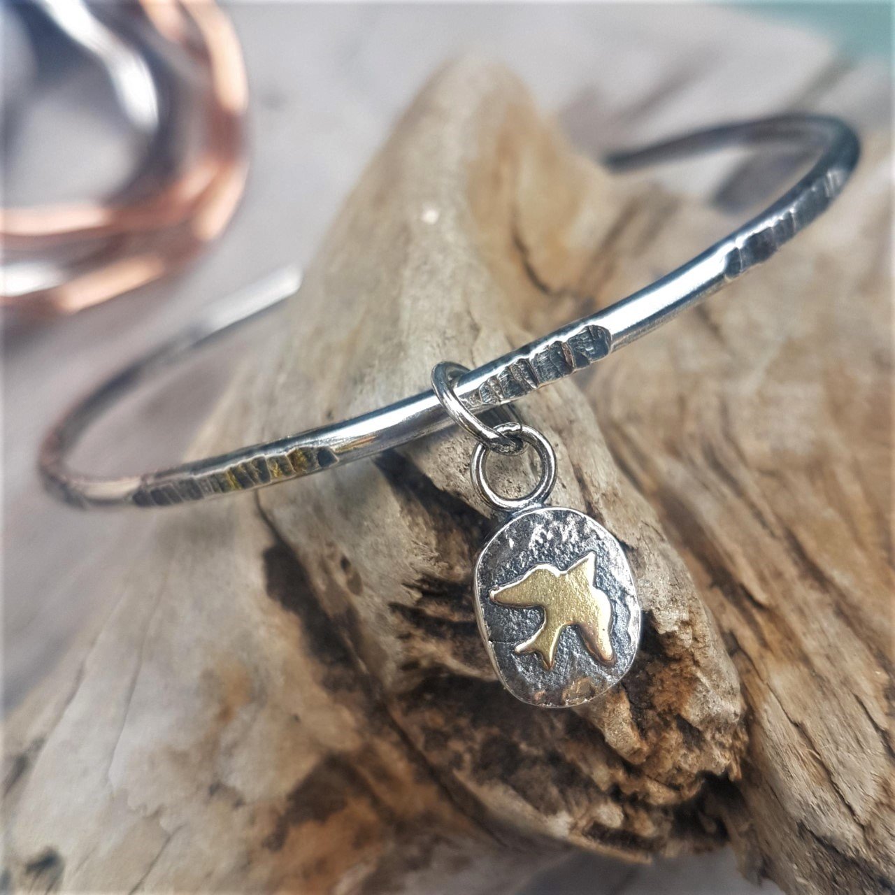 Handmade sterling silver bangle with gold bird charm