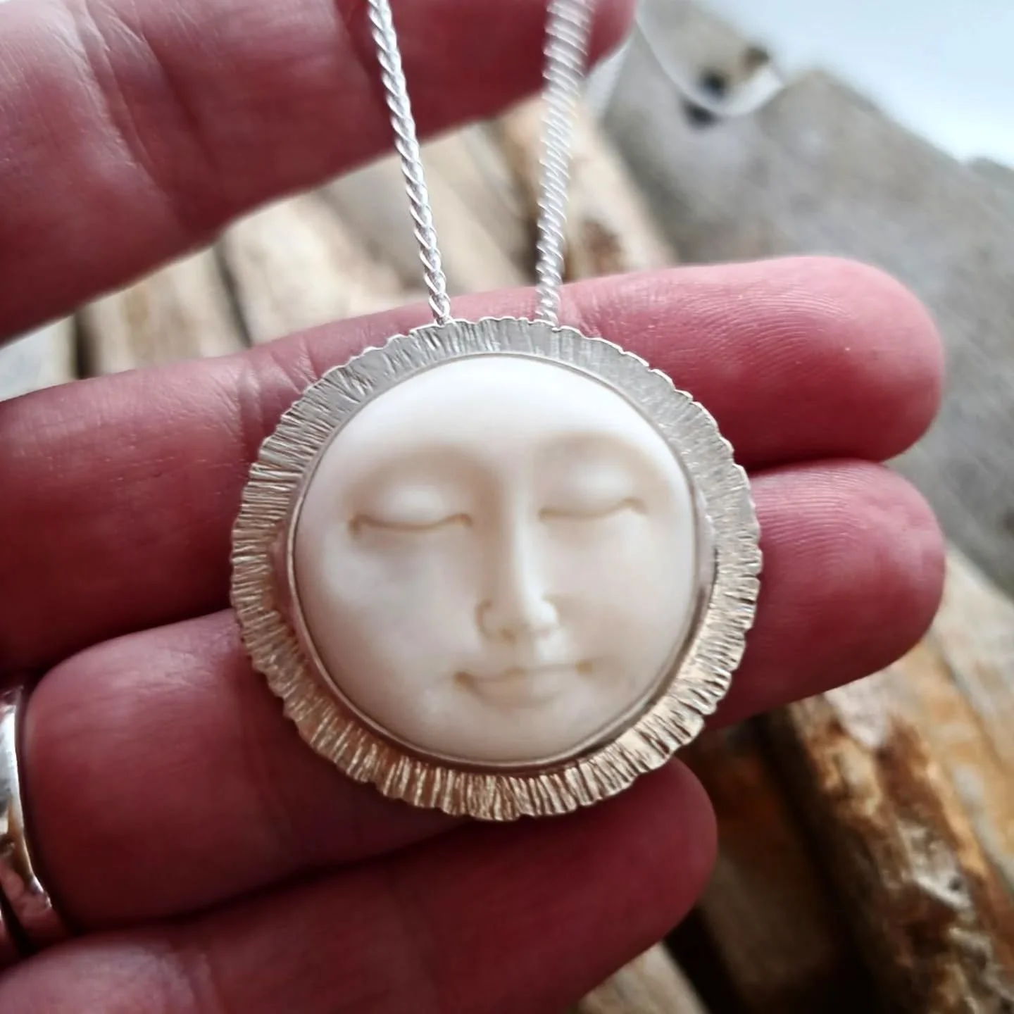 This beautiful bone* carving has been set into hammered sterling silver. I wanted the hammering to represent sun rays around the moon face. I'm so pleased with how striking it looks. 

https://www.ilovedollyjewellery.co.uk/necklaces-and-pendants/hand