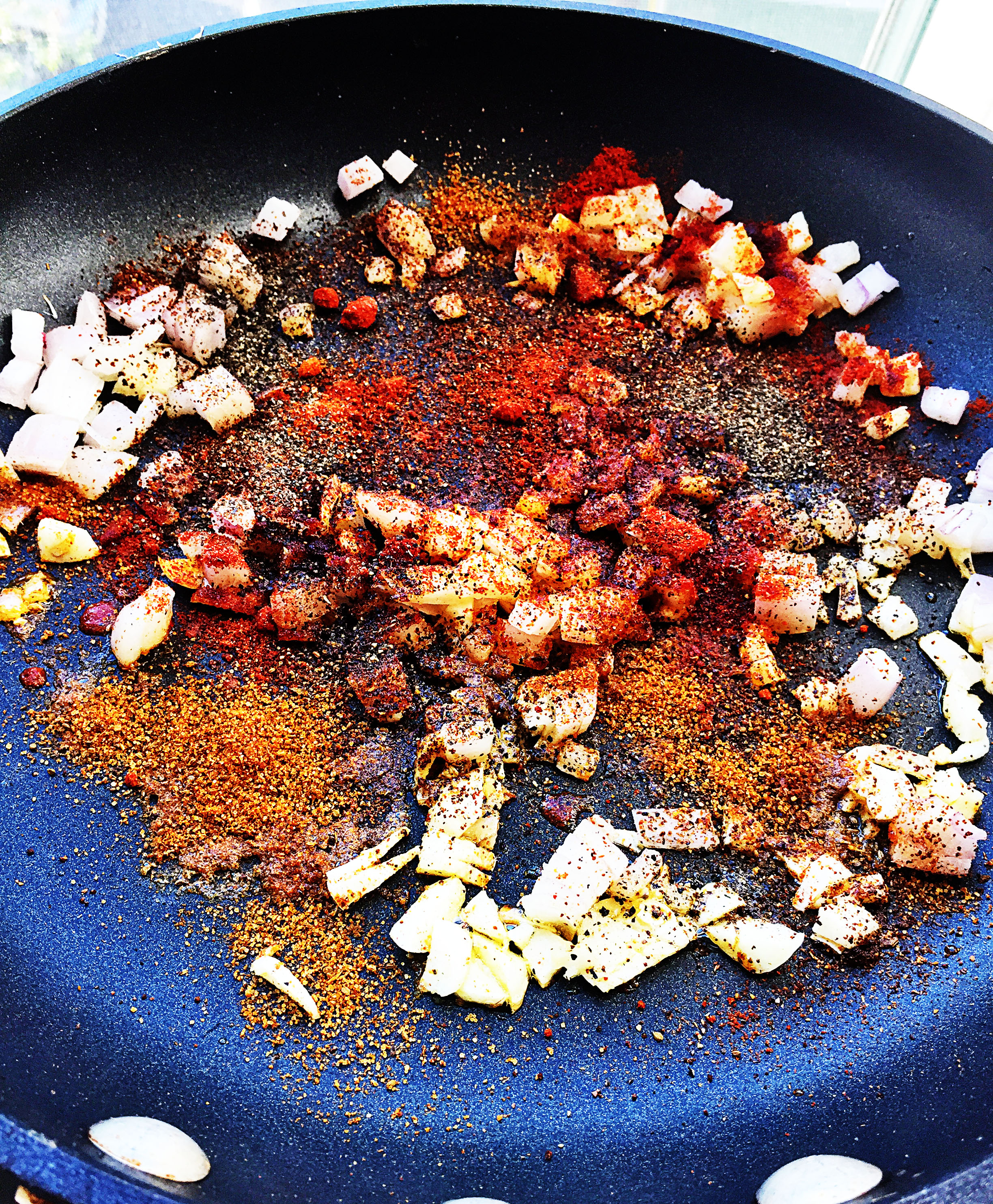 1. Once my prep work above is done, I start with my BBQ sauce. Place pan over medium heat with oil. Let it warm for 60 seconds and add onions + garlic. Let it cook for about 5 minutes until softening. Add all spices from paprika through pepper. Let it cook for another minute or two.