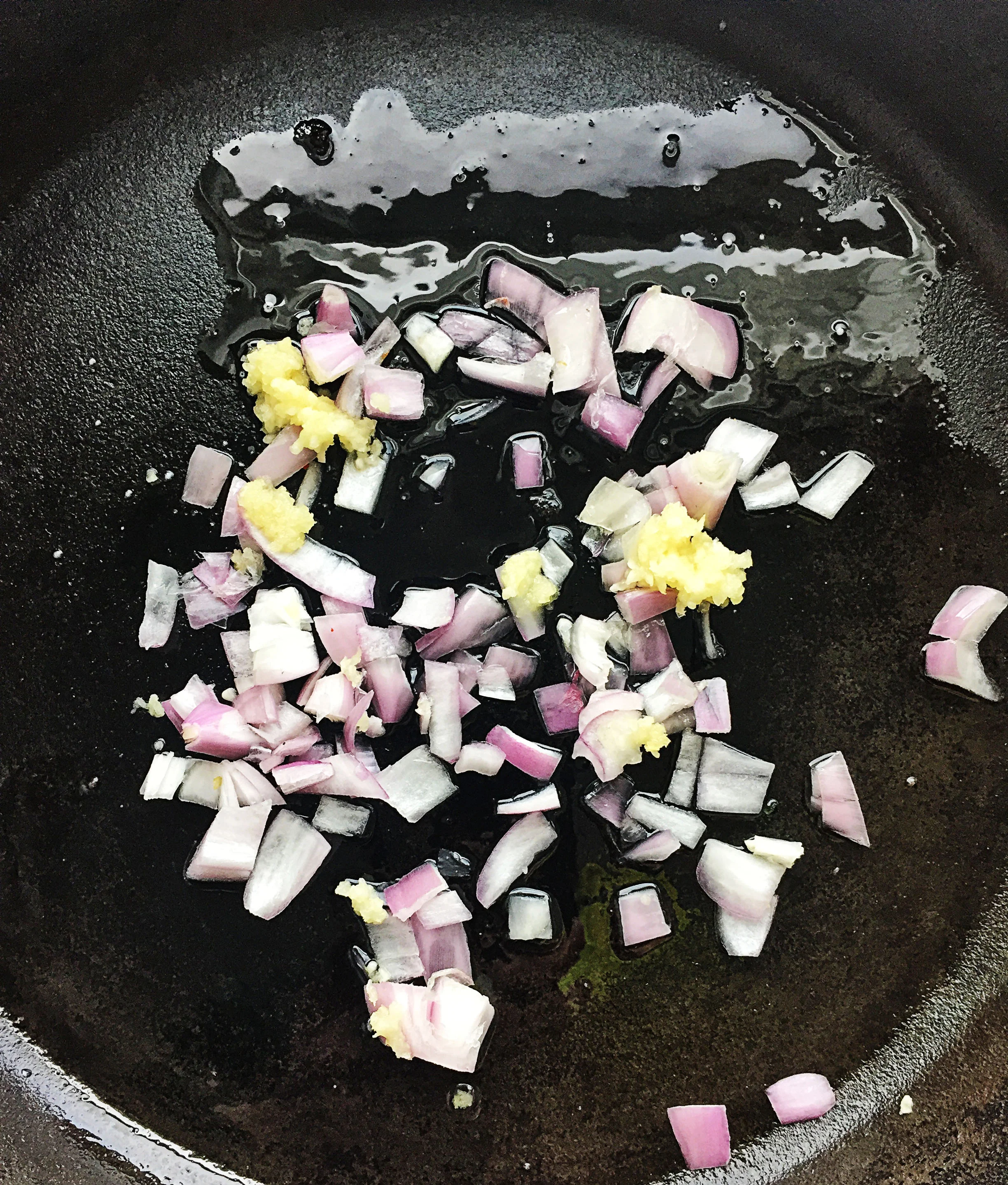 2. In a castiron pan, place oil, shallots, and garlic. Heat over medium heat and cook for 6 minutes until shallots begin to become translucent.