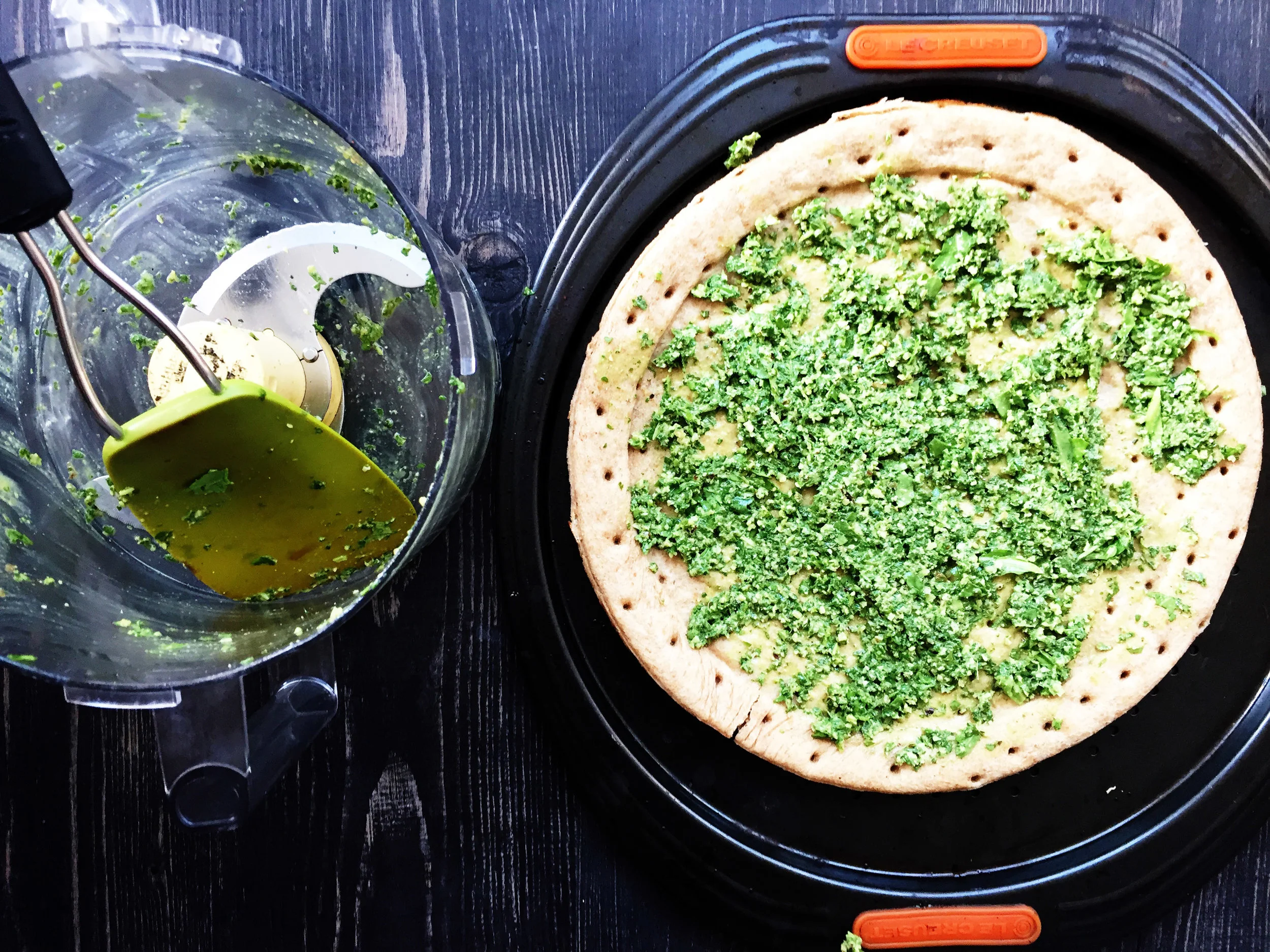 4. Take your pesto and spread it onto the pizza once it is done. We will continue to add ingredients to it. Set crust aside.