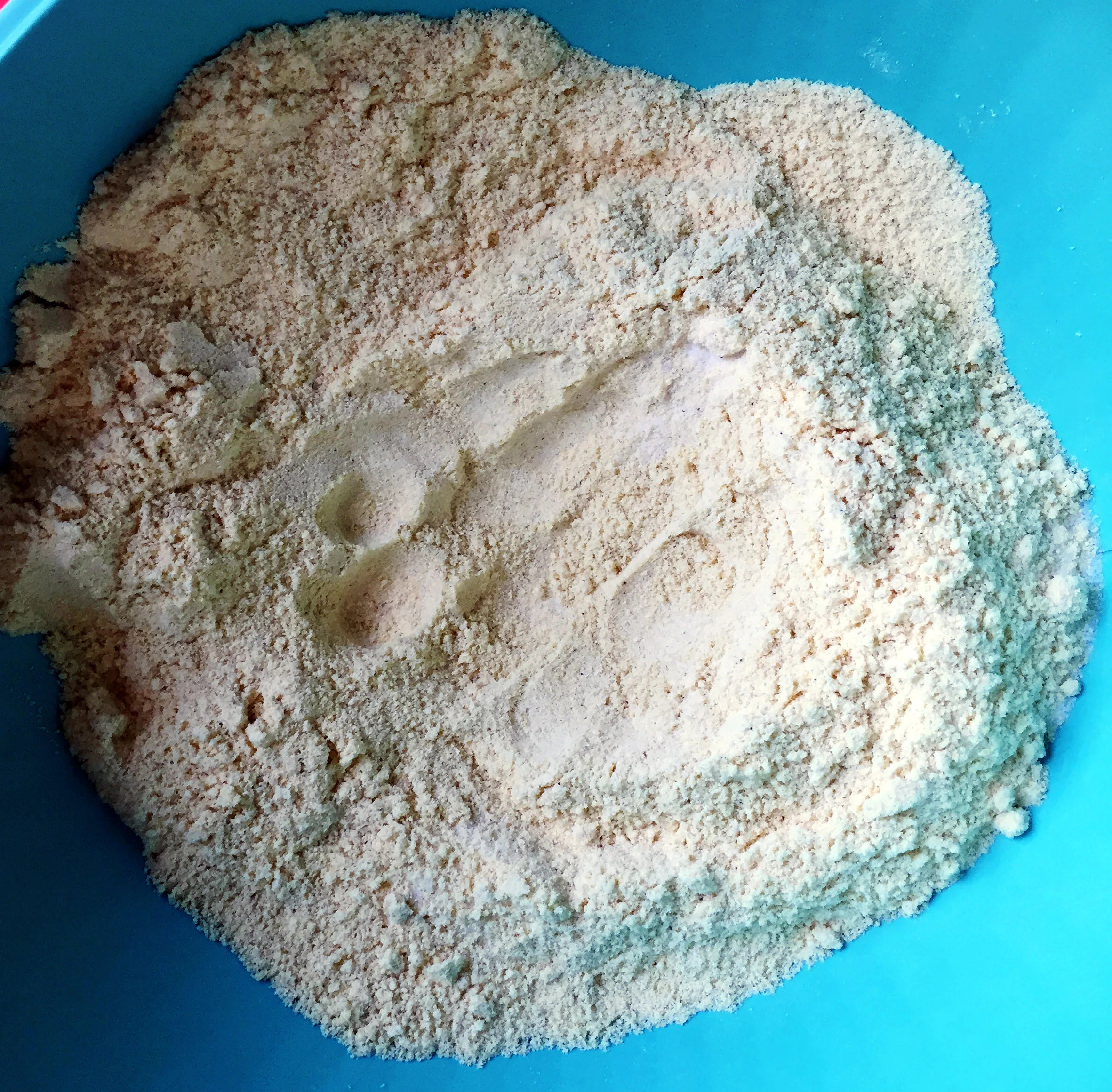 1. First, we want to combine the masarepa with the salt. Press down a well in the middle of the bowl.