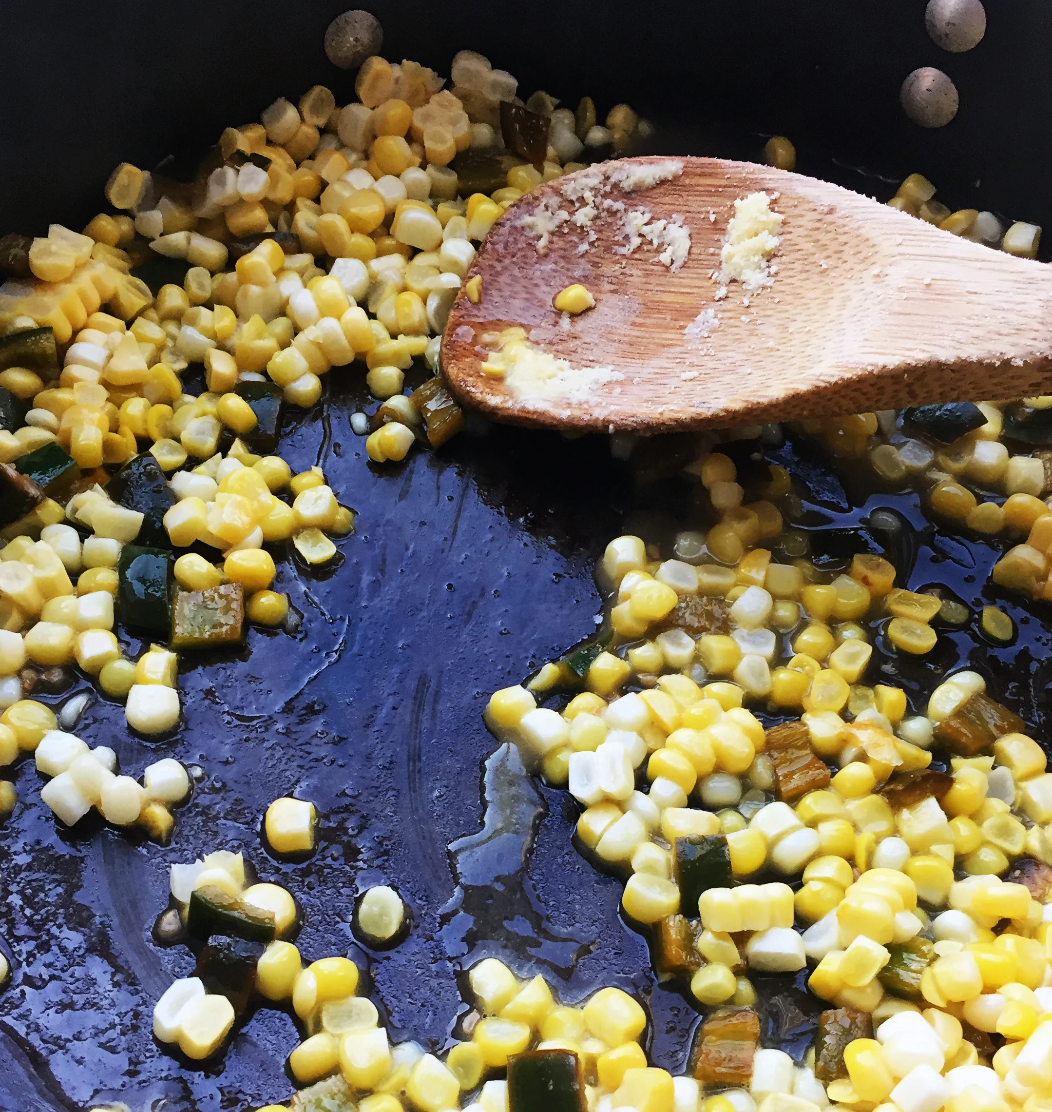 4. While the dough is sitting, add all the corn ingredients to a medium pan. Turn onto medium heat. Stir together well. Cook for 8-10 minutes until the mixture starts to stick to your wooden spoon.