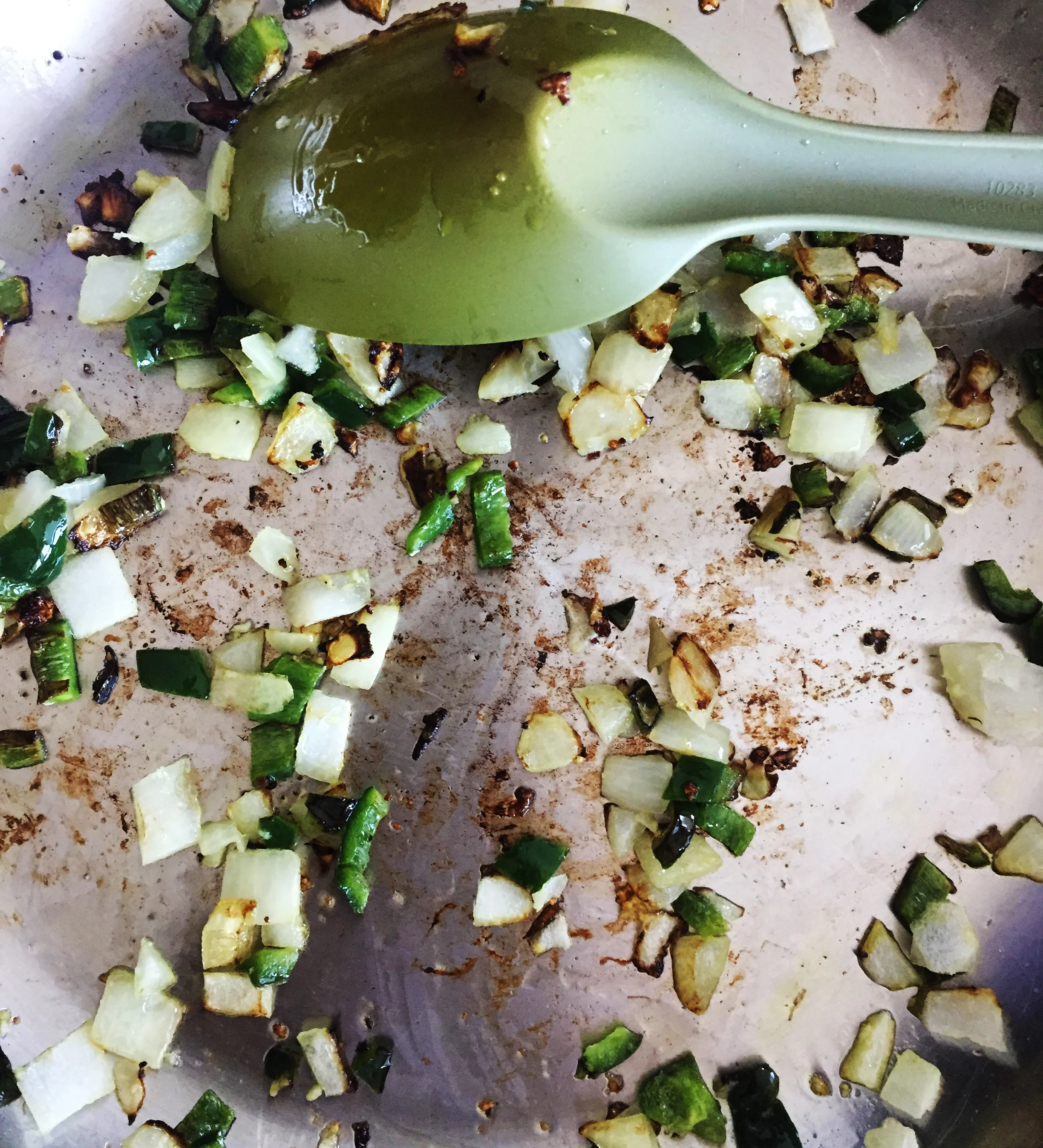 1. While waiting for the chia egg to form, put oil, onions, and peppers into large frying pan. Saute for 8 minutes until starting to brown over medium heat.
